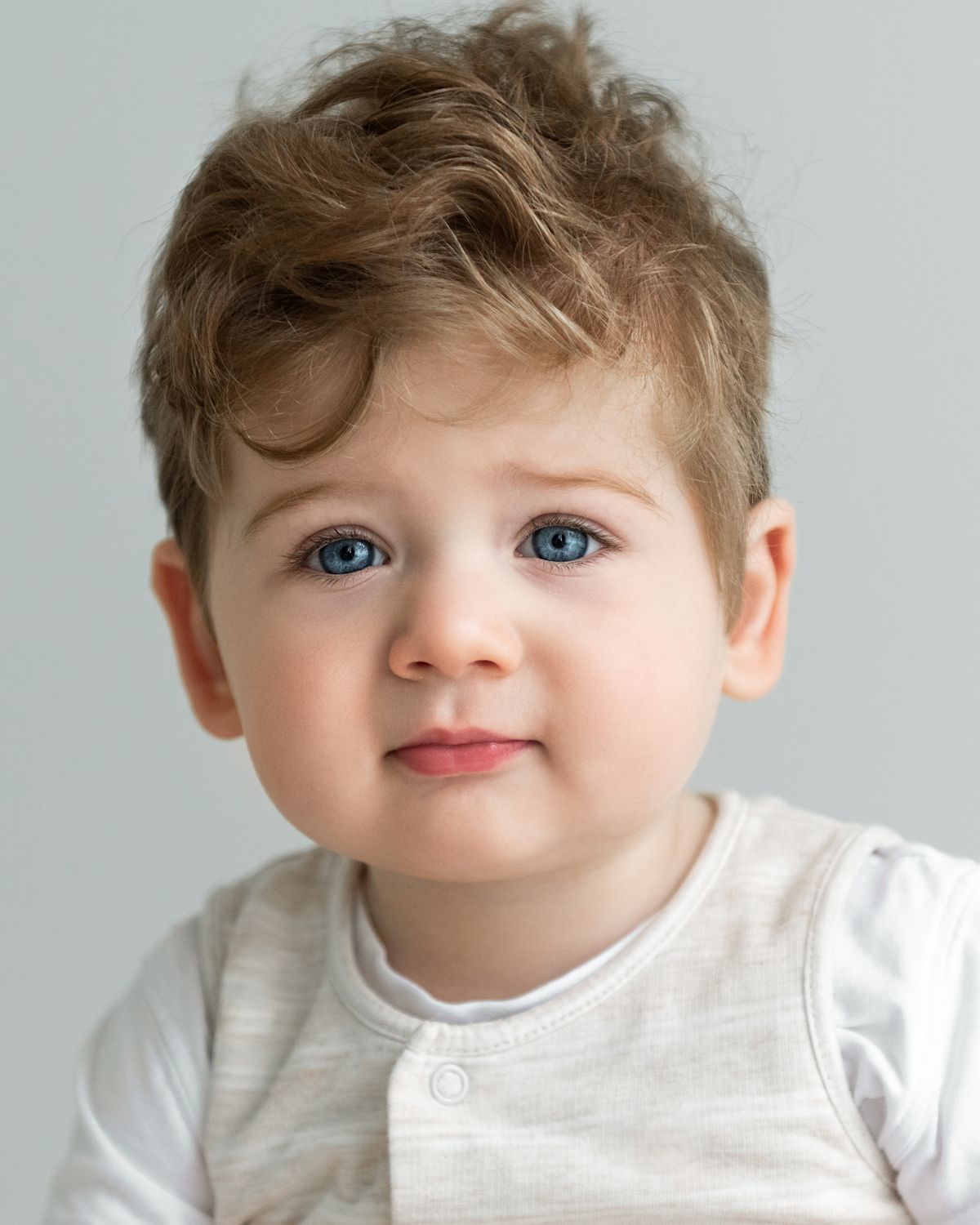 Close-up portrait series on white background showcasing soft expressions.