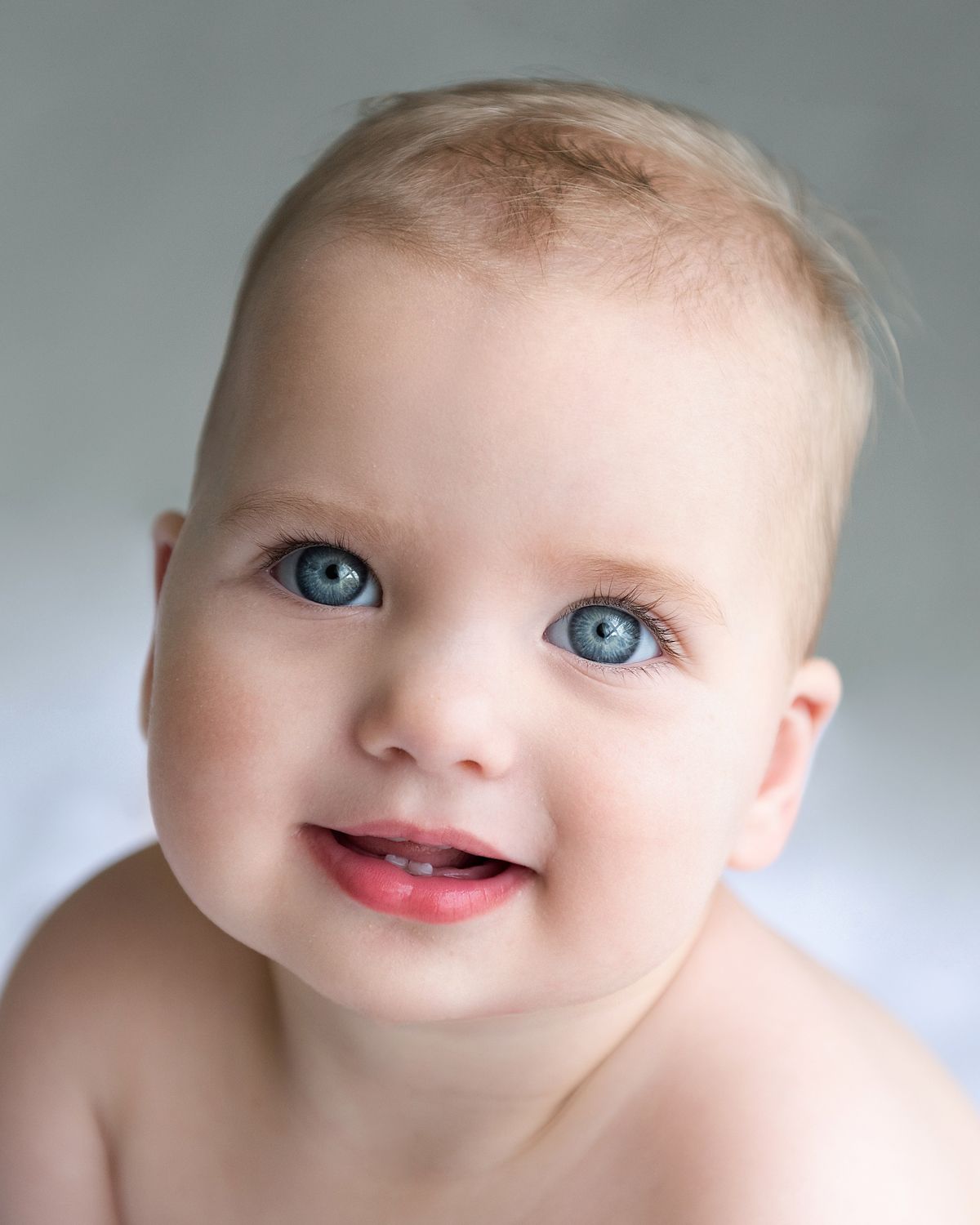 Artistic macro photography series highlighting bright blue eyes and gentle expressions.