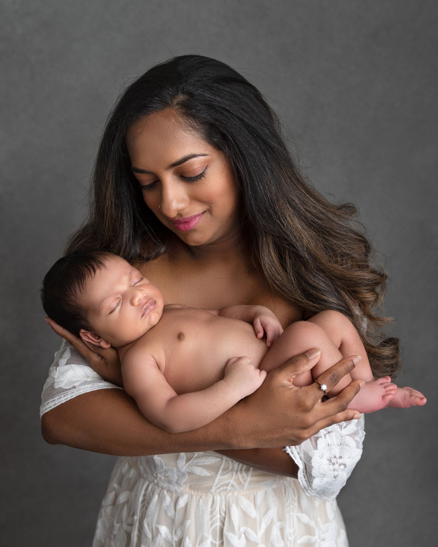 Intimate black and white newborn photography session showing parental bond.
