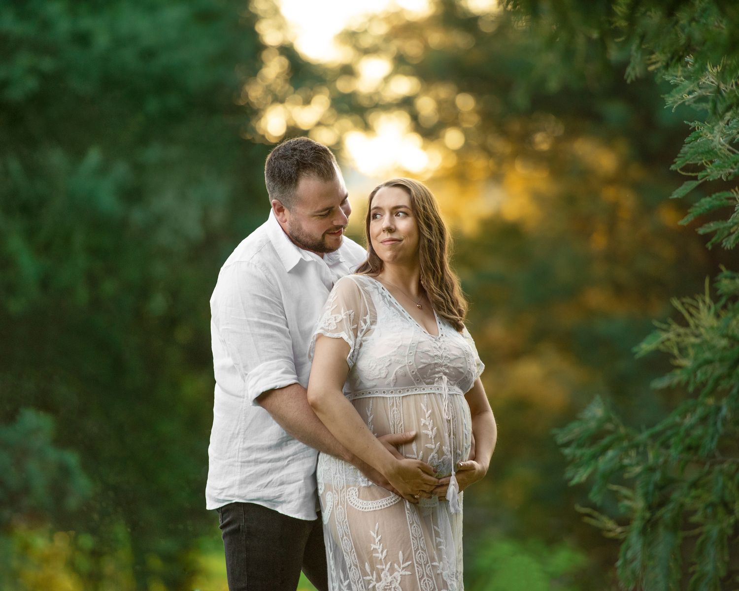 Romantic couple photoshoot in golden hour light with natural outdoor setting.