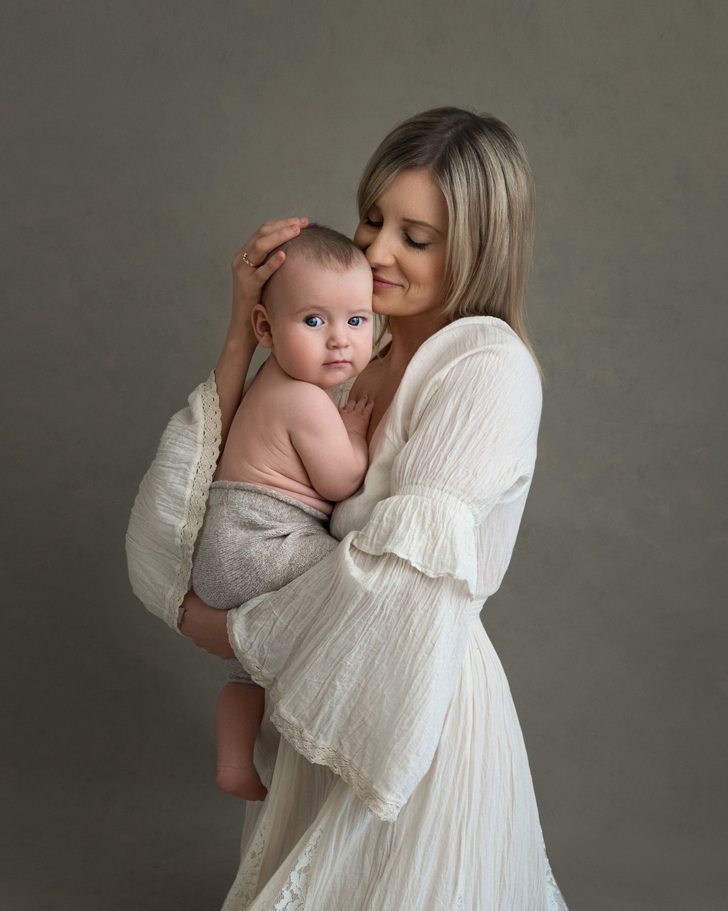 Intimate studio portraits featuring flowing white dresses against a neutral backdrop.