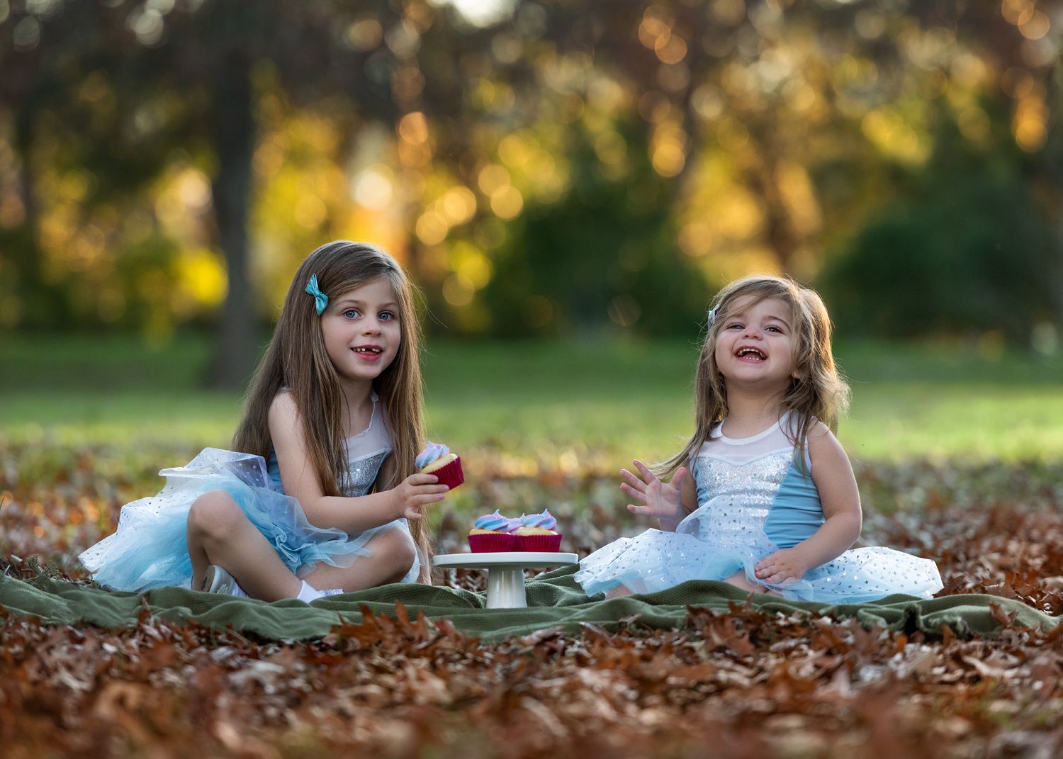 Playful autumn photography session with fallen leaves.