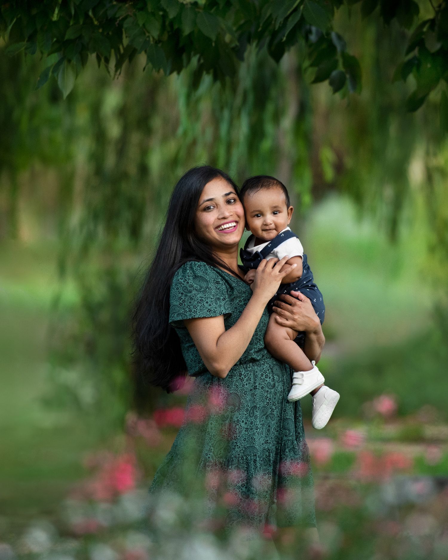Outdoor portraits in a green garden setting with soft natural lighting.