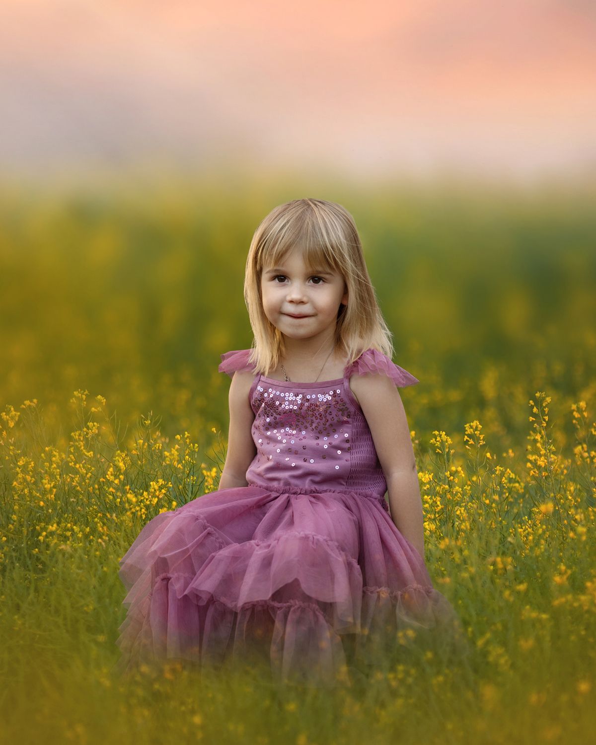 A purple tulle dress twirls in a field of yellow wildflowers at sunset.