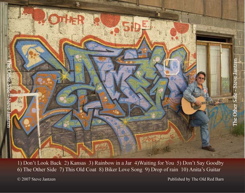 Colorful graffiti art on a concrete wall with song titles listed below.