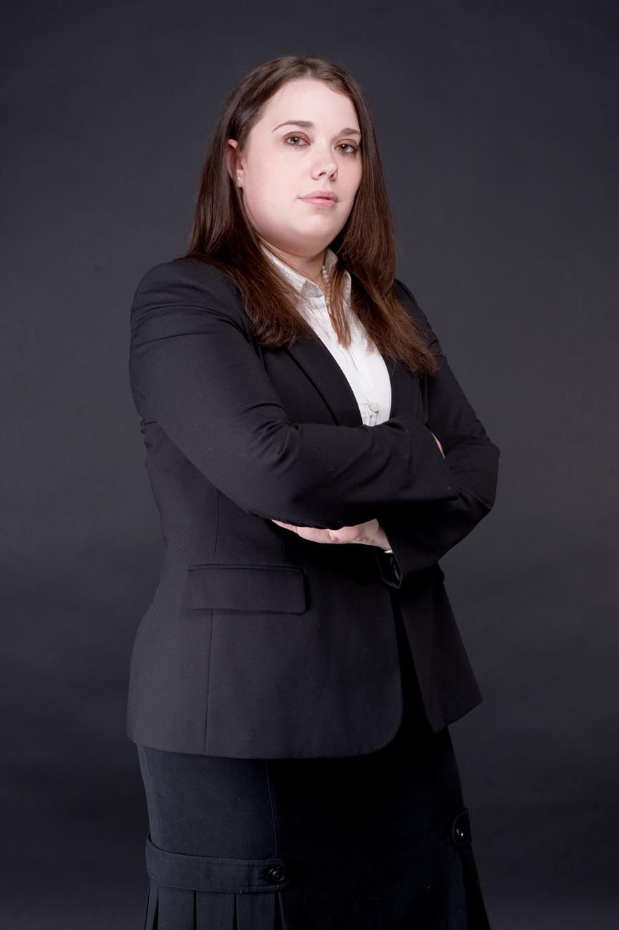 Professional portrait series of a person in a black blazer against dark background.