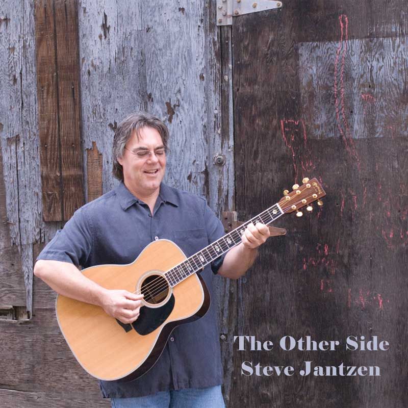Album cover showing a musician with an acoustic guitar against a weathered wall.
