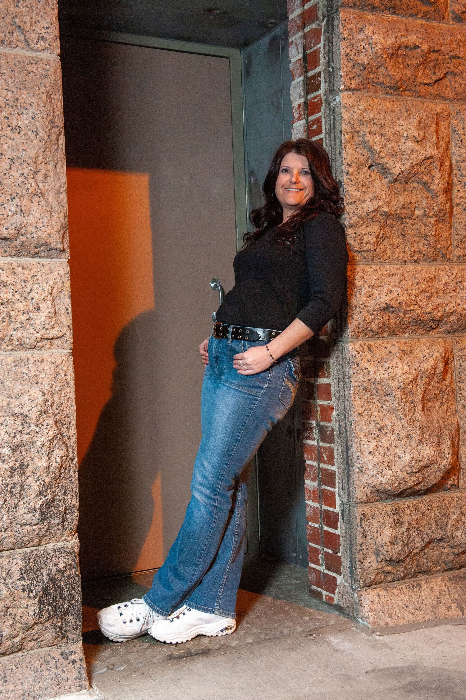 A series of photos showing someone posing against a stone wall entrance.