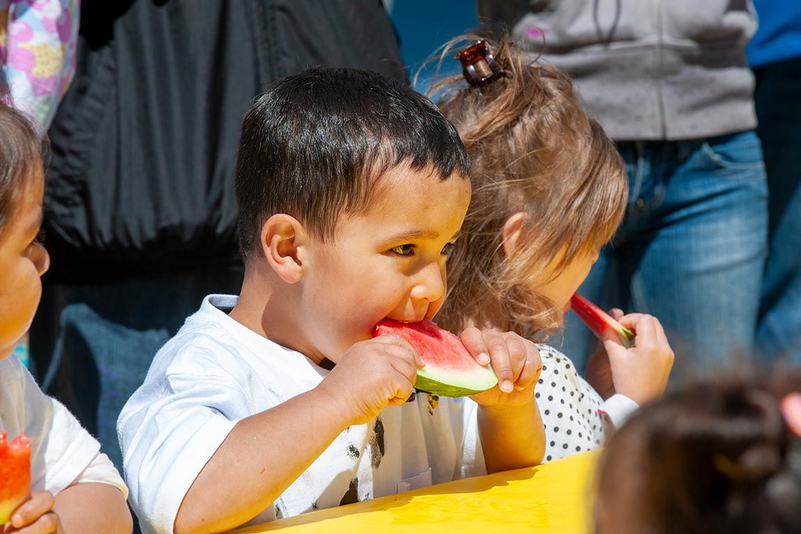 Children eating snacks and treats at a party or celebration.