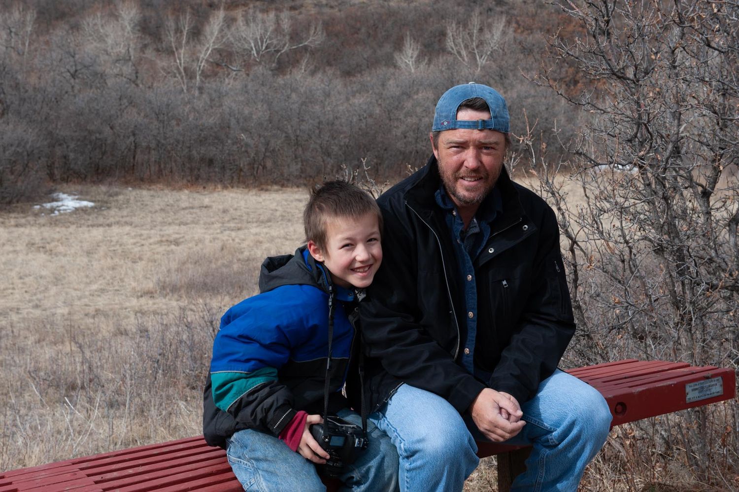 A series of candid outdoor photos showing people sitting on a red bench in a natural winter setting.