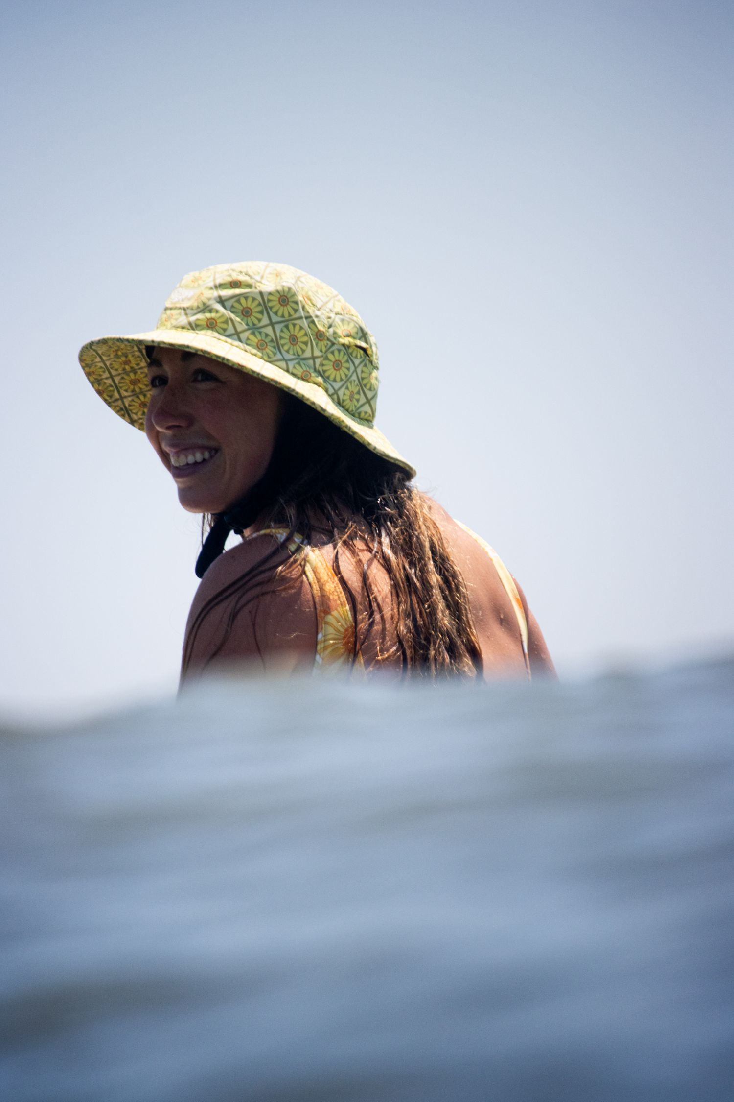Female surfer portrait in ocean, in-water lifestyle photography