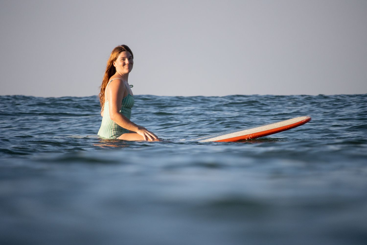 Female surfer portrait in ocean, in-water lifestyle photography