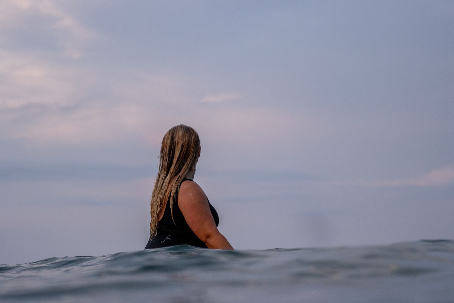 Female surfer portrait in ocean, in-water lifestyle photography