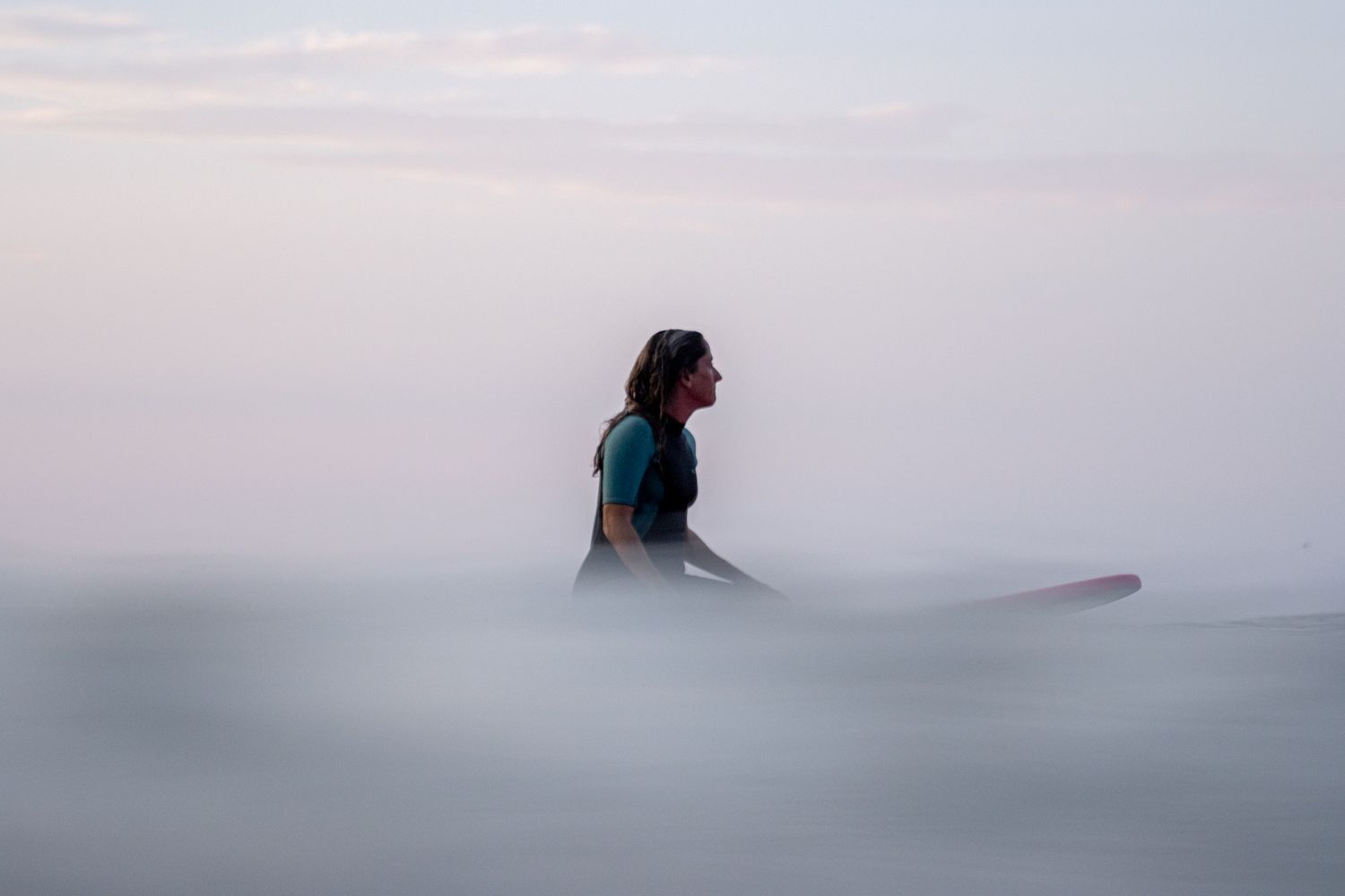 Female surfer portrait in ocean, in-water lifestyle photography