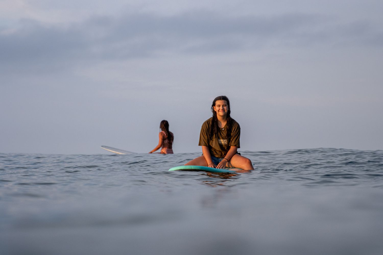 Female surfer portrait in ocean, in-water lifestyle photography