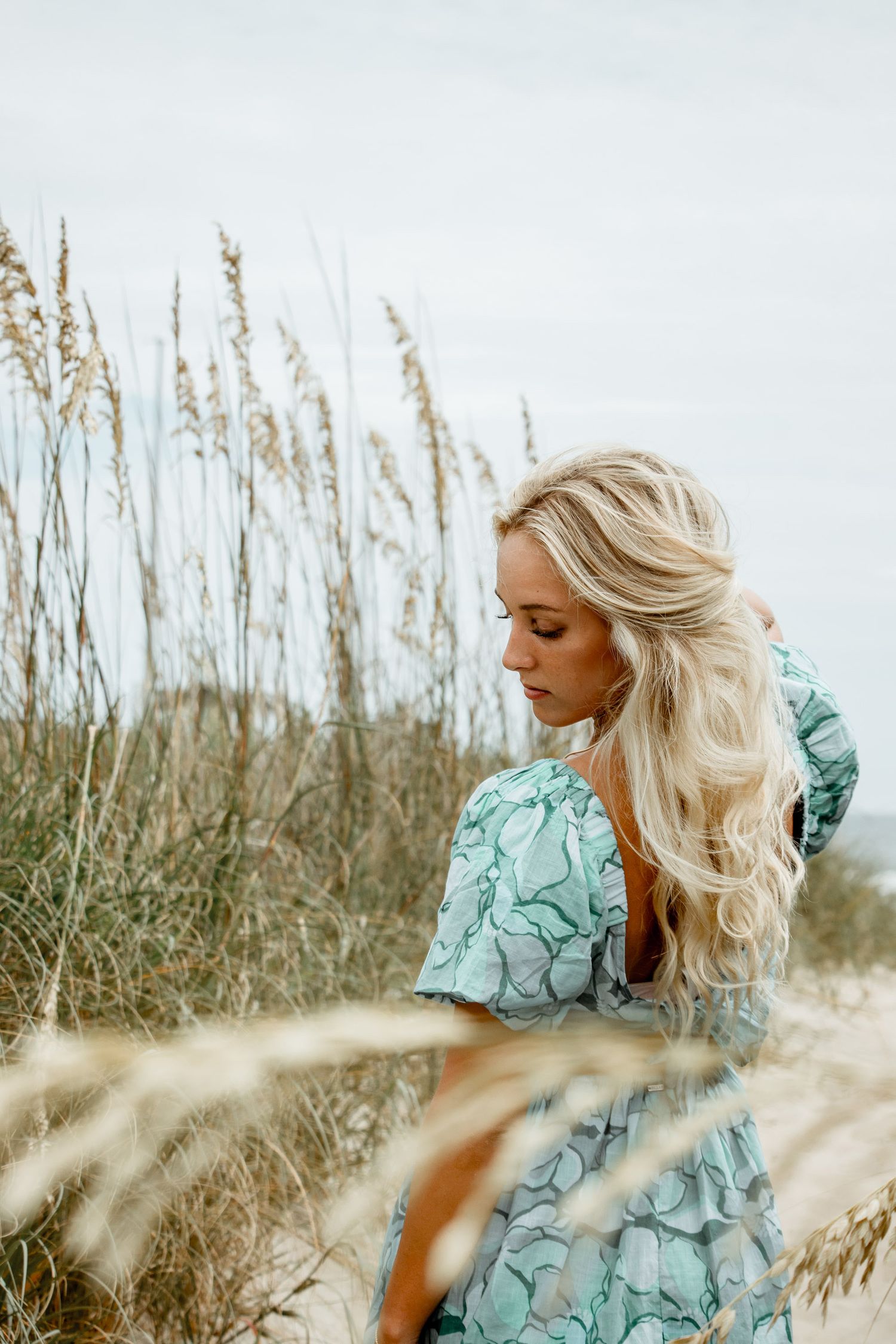 Lifestyle beach portrait of woman in coastal grasses, Outer Banks North Carolina photographer