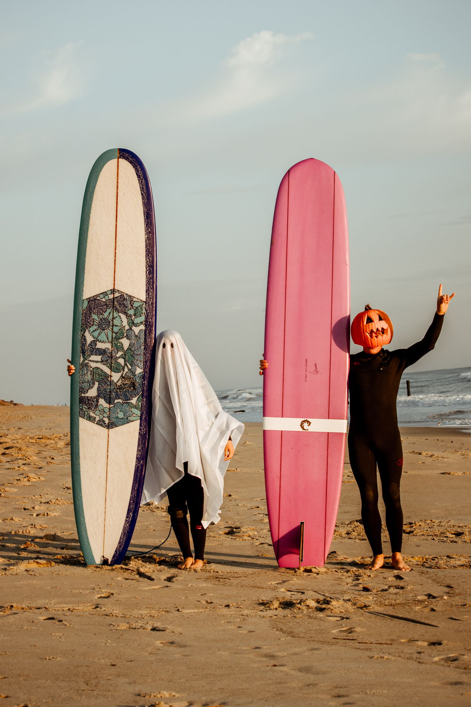 Halloween surfing lifestyle shot of surfers with their boards in costumes
