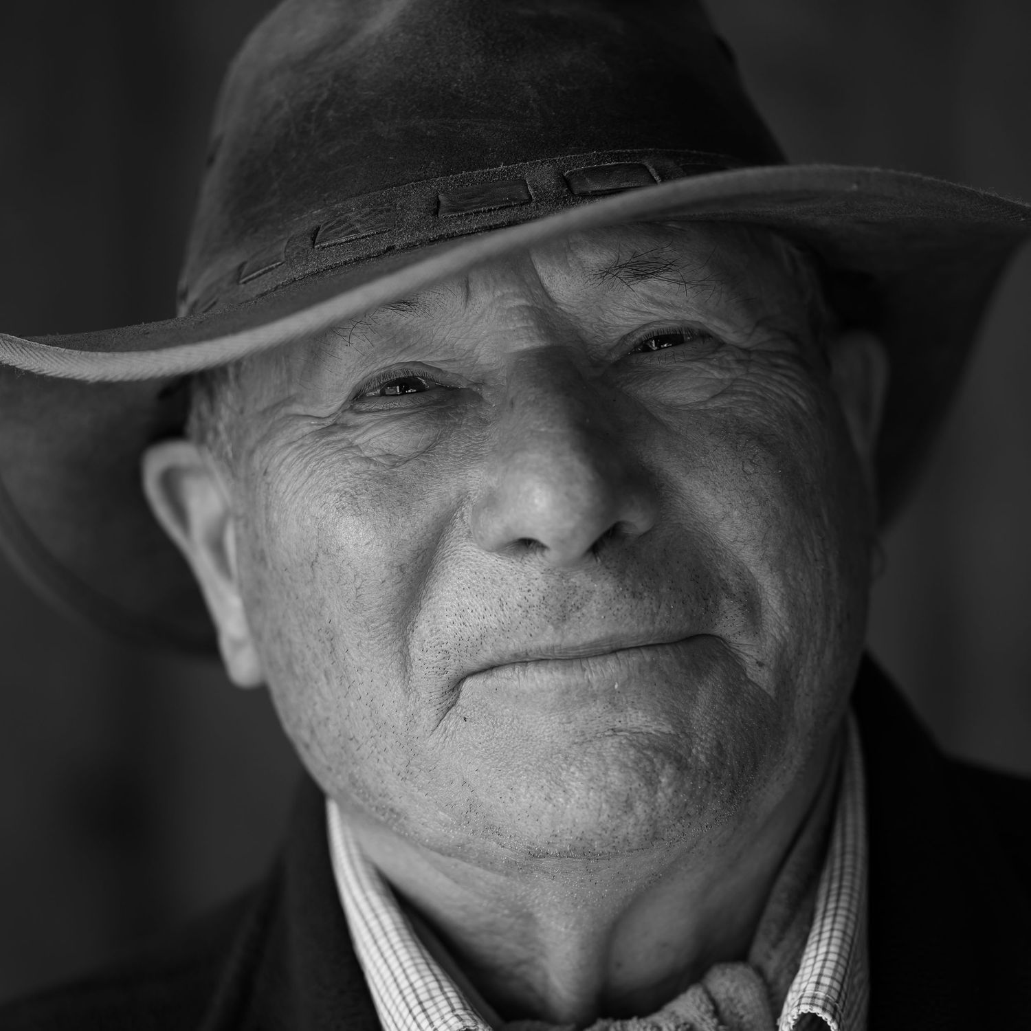 black and white portrait of one of the beaters, taken in a barn during a lunch break of a game shoot