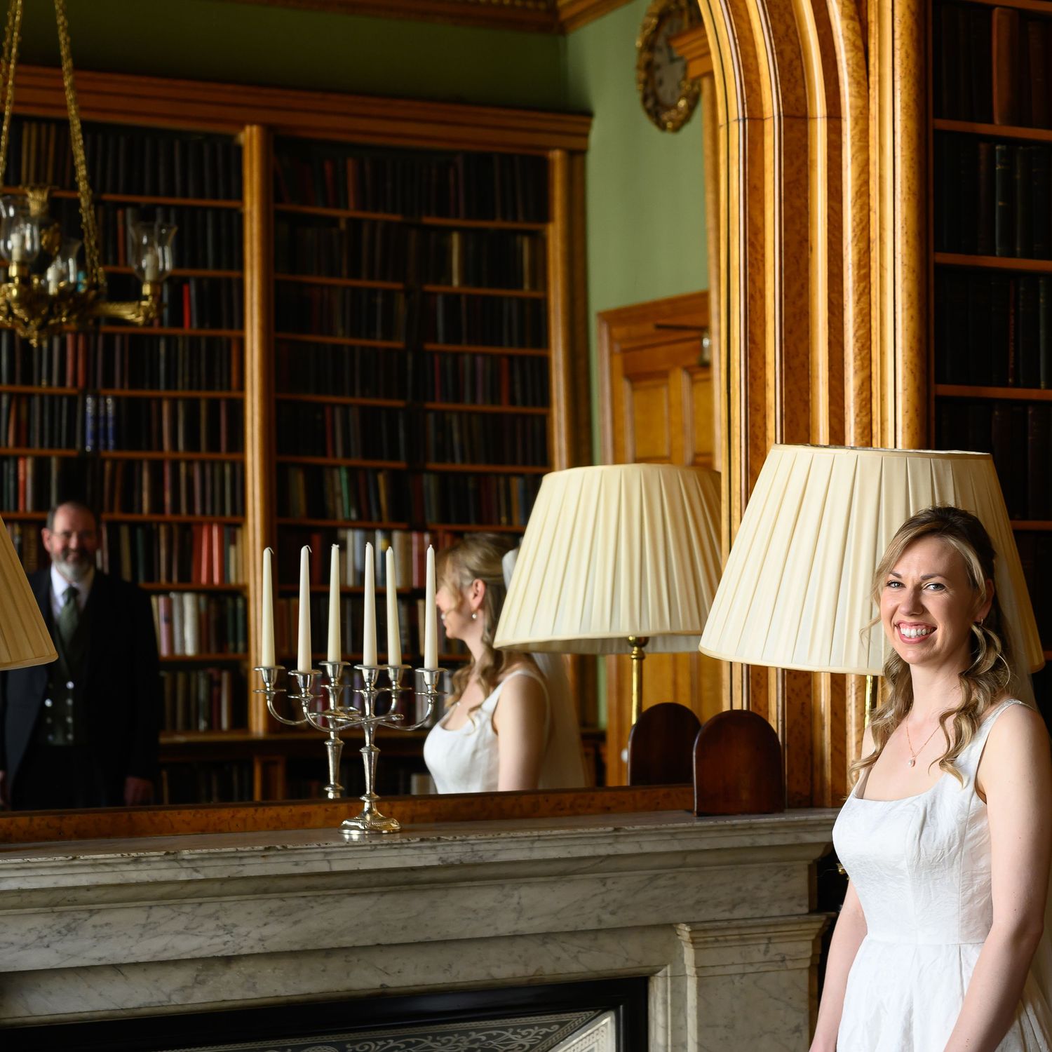 Bridal portrait at the iconic Reform Club, London, with creative mirror use showing the father admiring his daughter before the wedding.