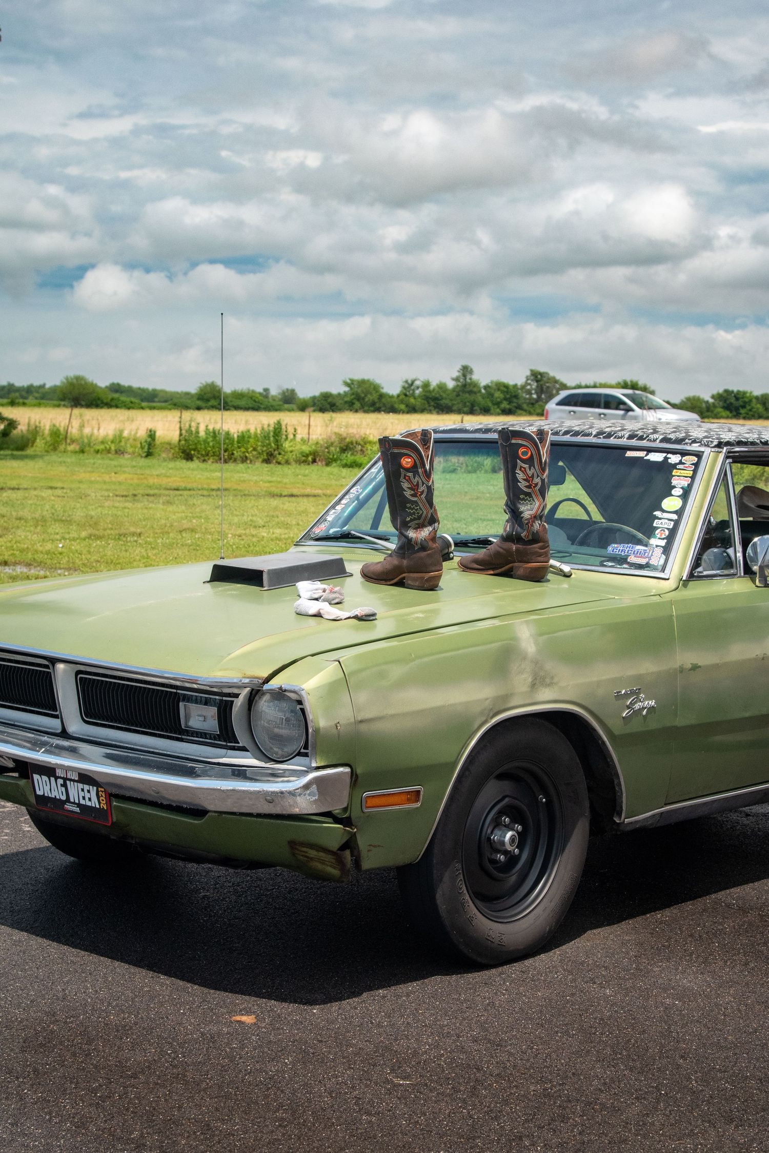 green Dodge dart with boots on its hood