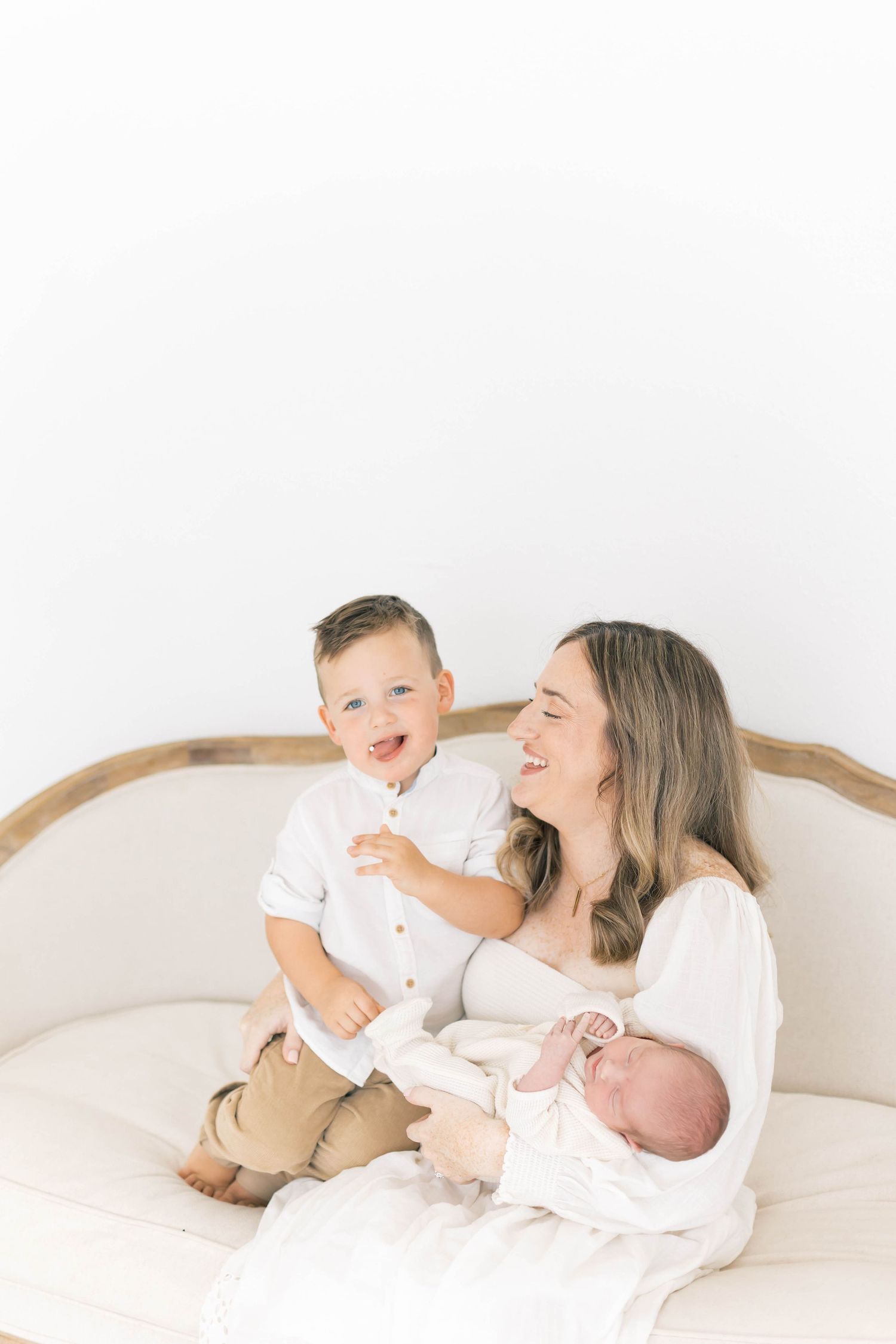 Joyful family lifestyle session with children on vintage furniture.