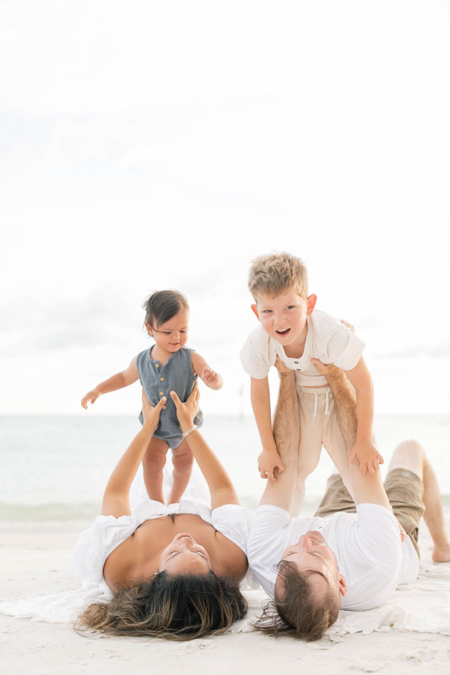 Playful beach photography sequence showing family interaction on white sand.