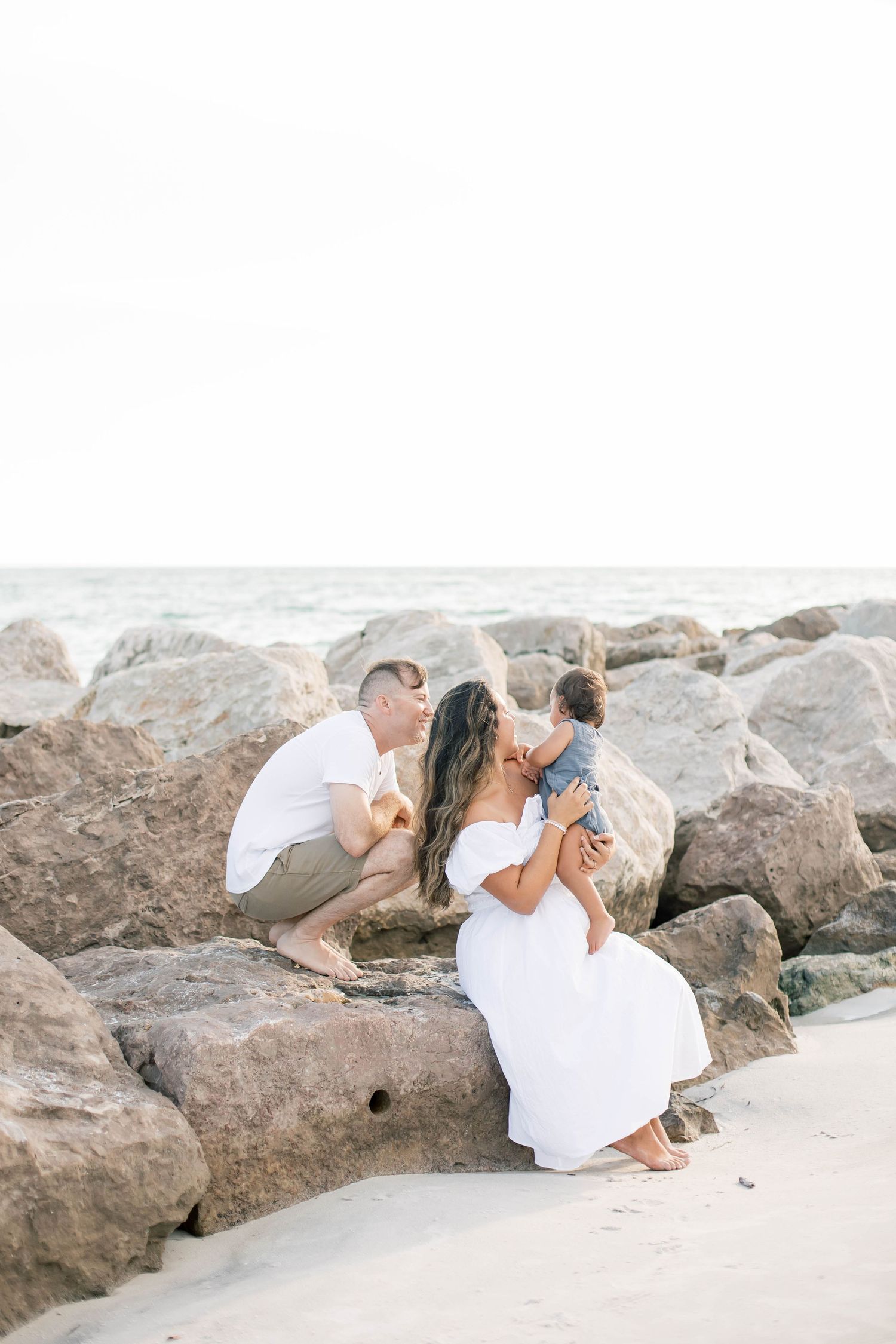 Natural family photography session along a rocky oceanfront.