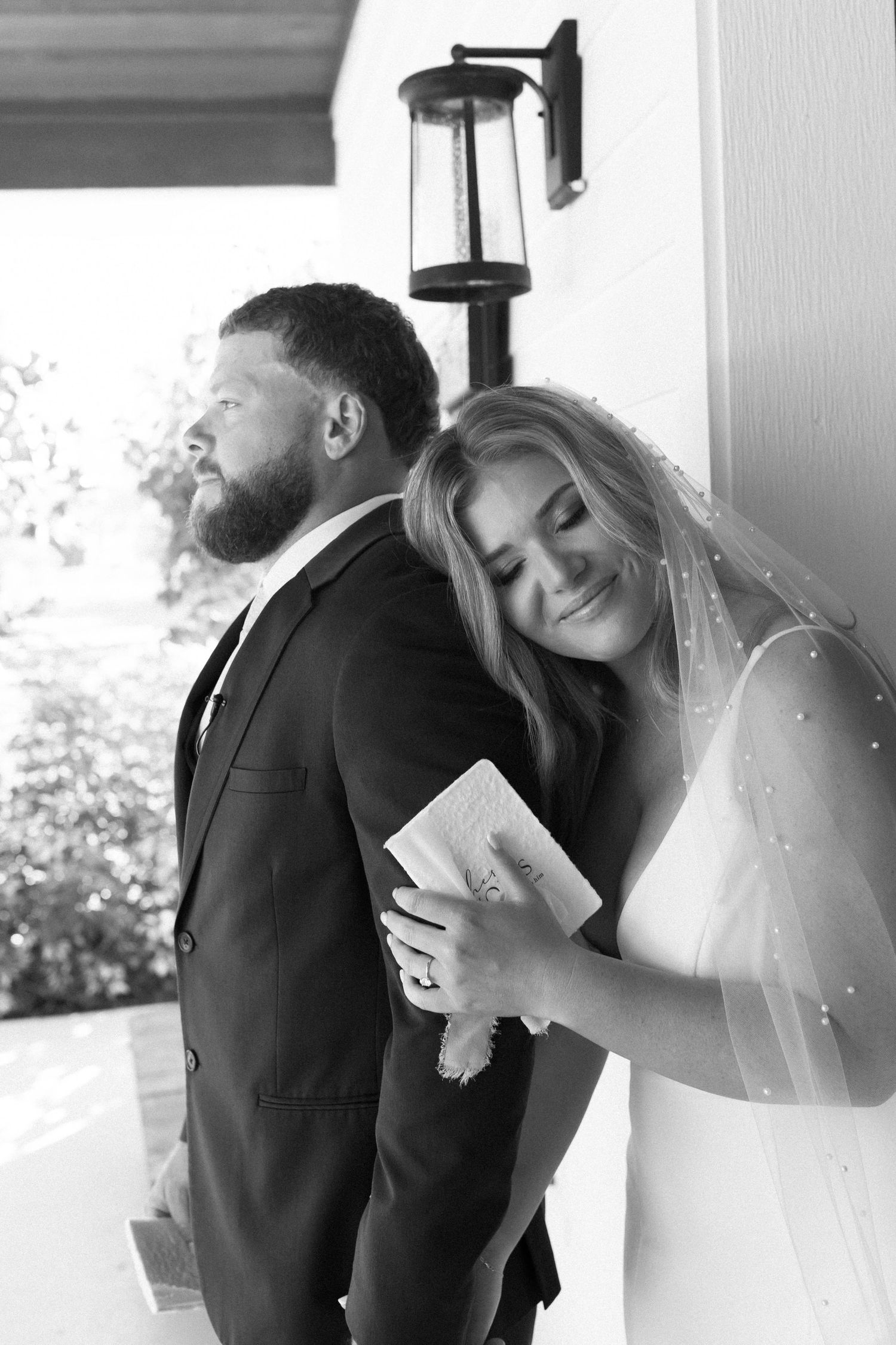 Black and white wedding photos showing tender moments between newlyweds.