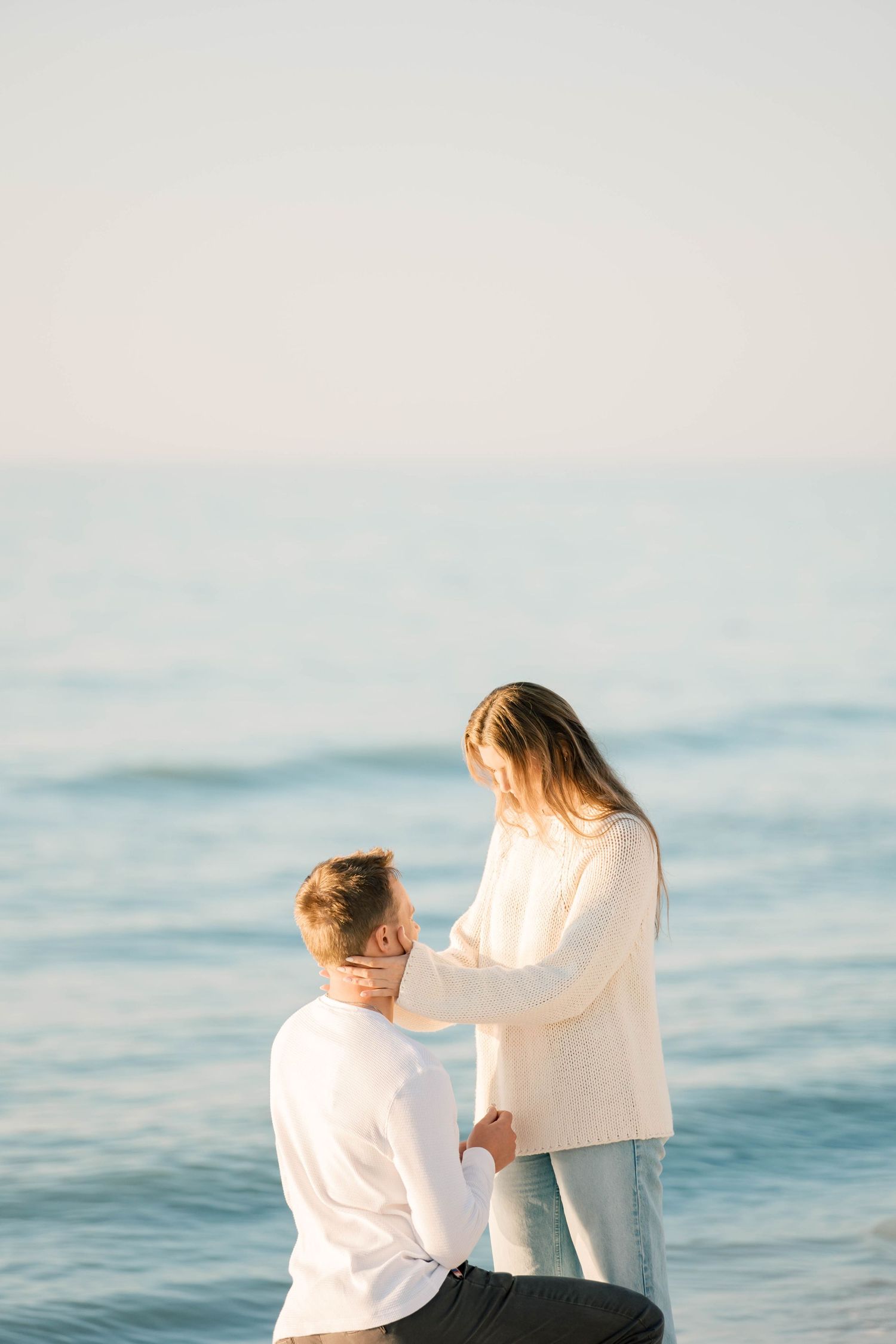 Series of photos showing a proposal scene by the ocean at sunset.