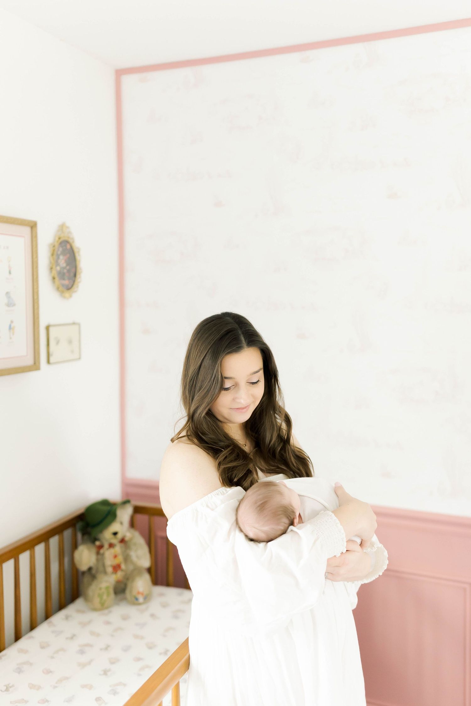 Intimate portrait session in nursery with white and pink decor.