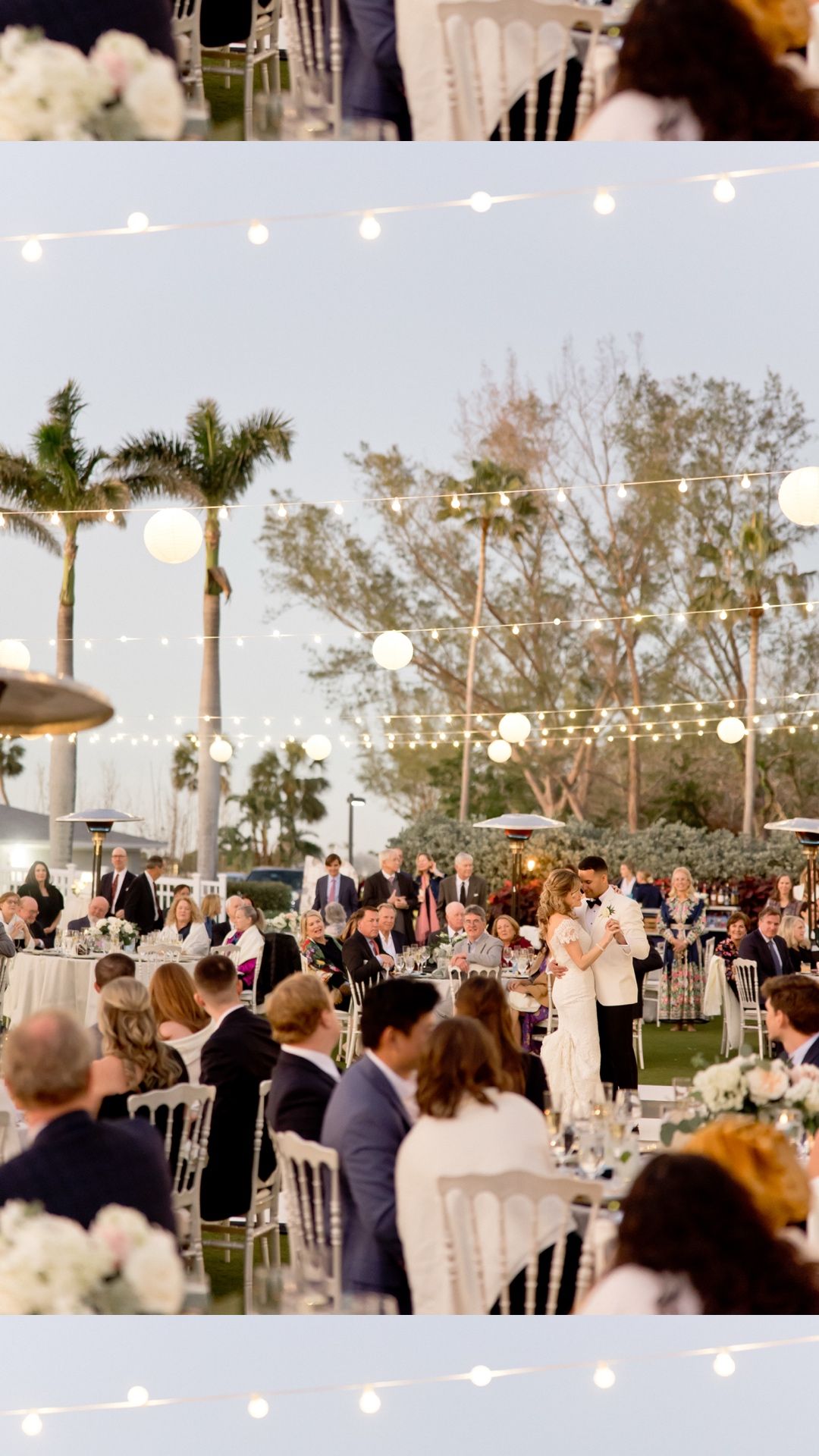 Evening wedding reception under string lights with palm trees and guests.