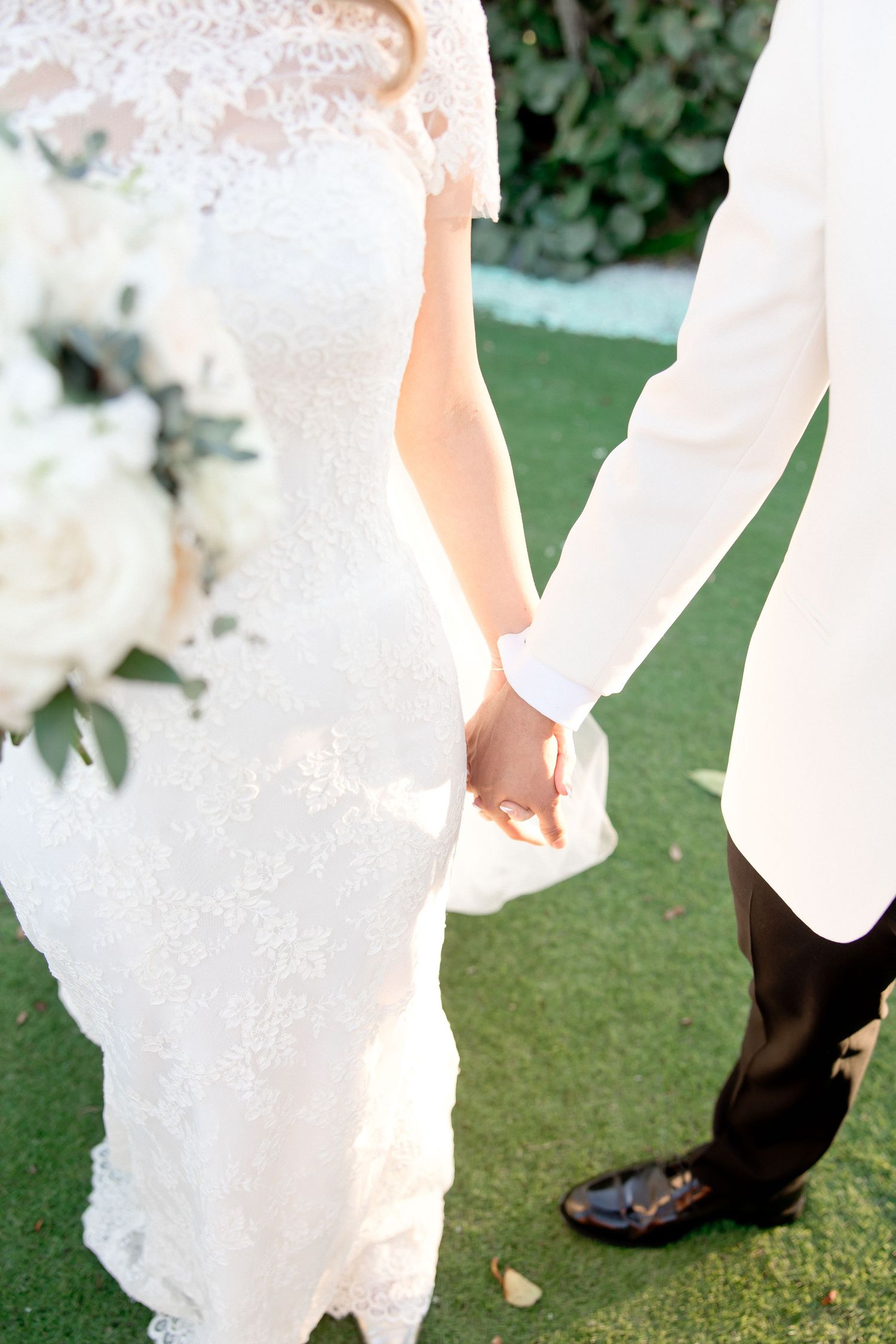 Detail shots of wedding attire and formal shoes on a manicured lawn.