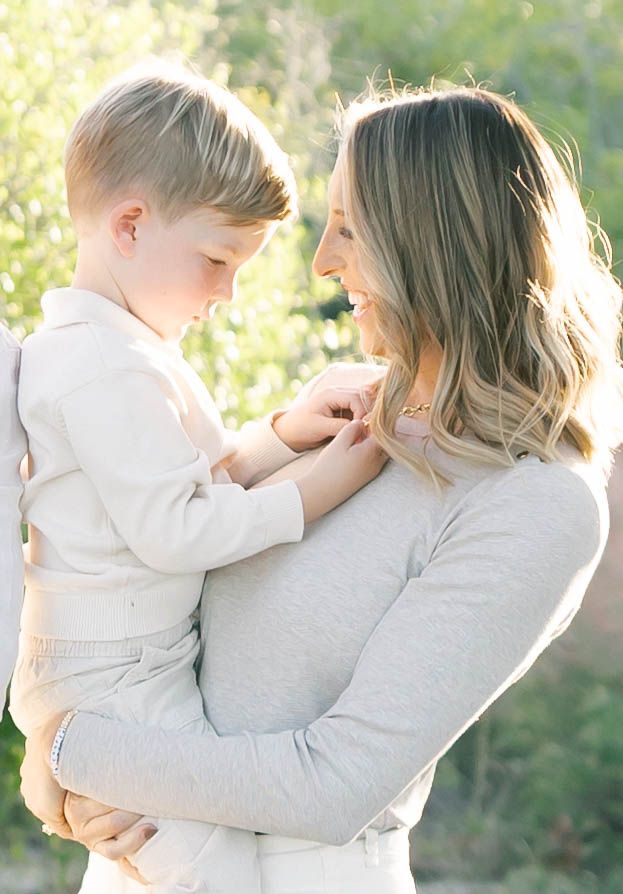 A tender moment captured between parent and child in soft natural lighting.