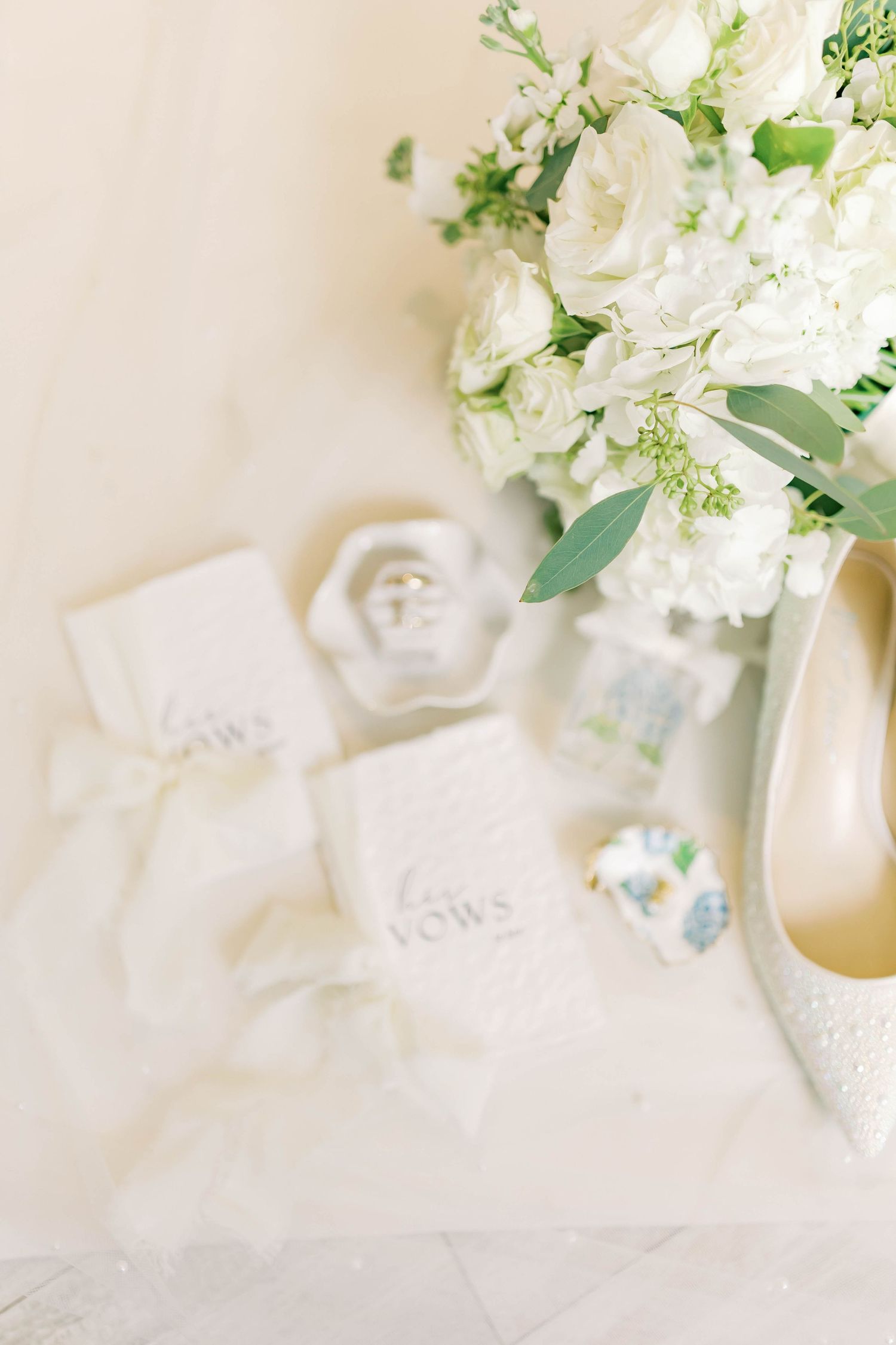 Wedding details with white floral arrangements and delicate paper elements.