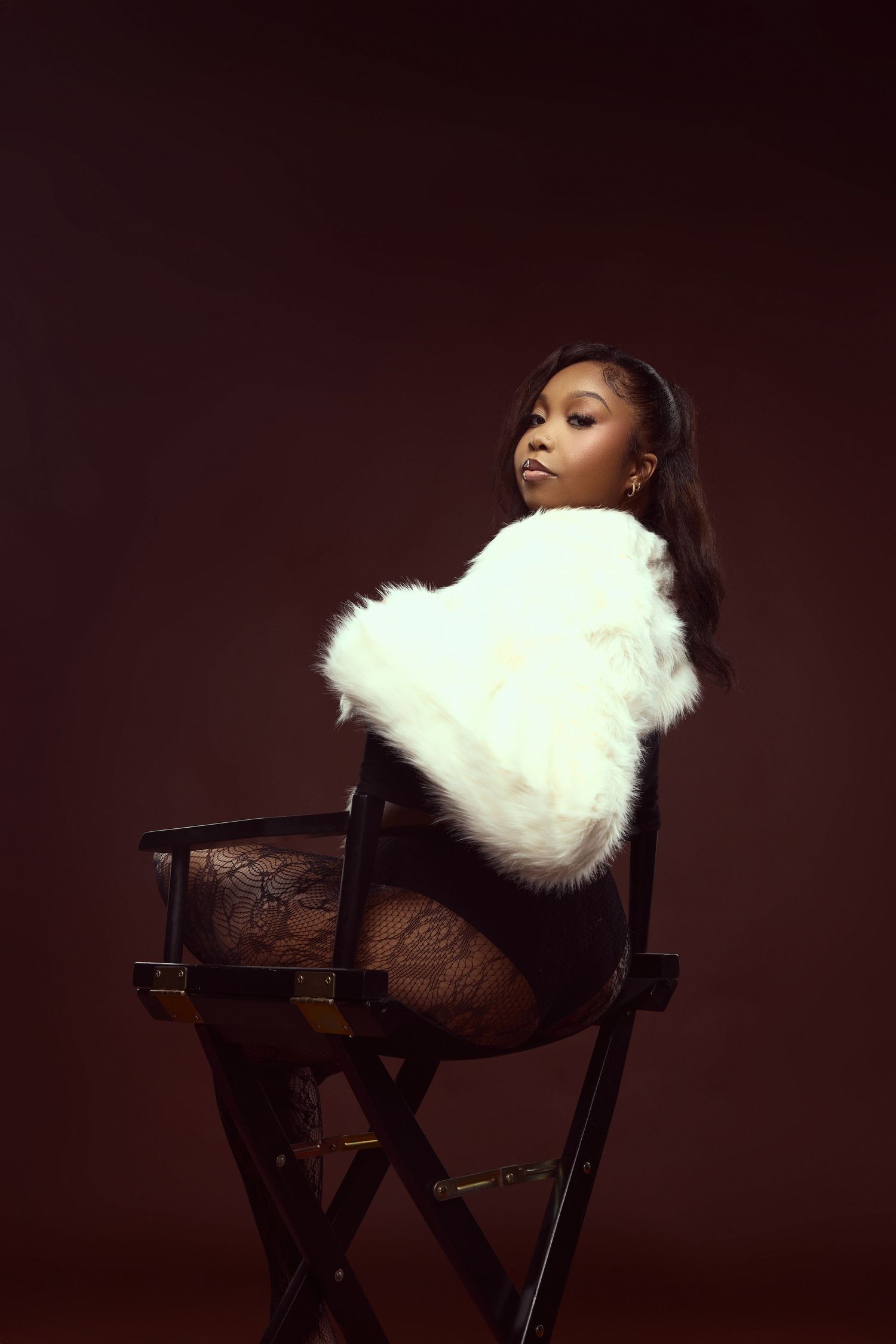 A dramatic portrait series showing a white fur pillow on a dark wooden chair against a deep brown background.