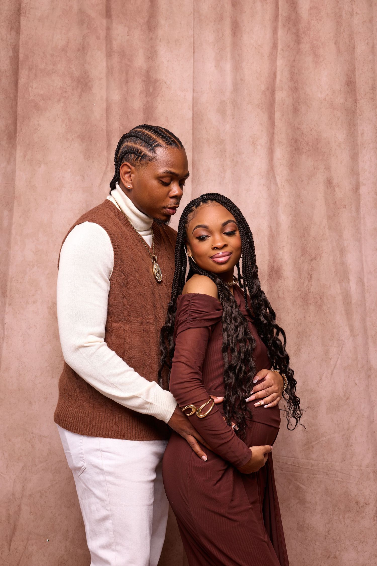 Intimate couple portrait series in brown and white tones against textured backdrop.