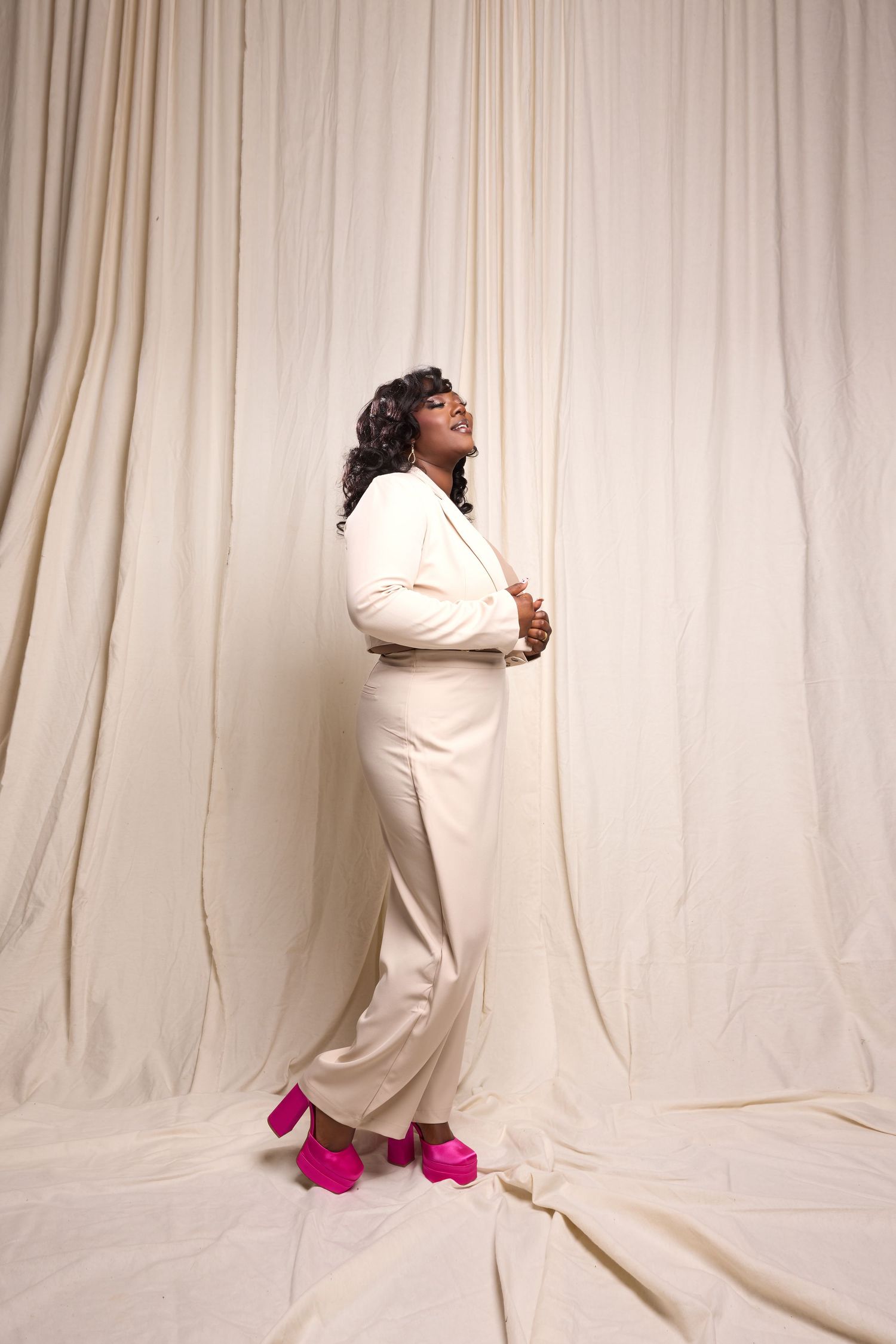 Person in white outfit with bright pink shoes poses against light backdrop in dynamic photo series.