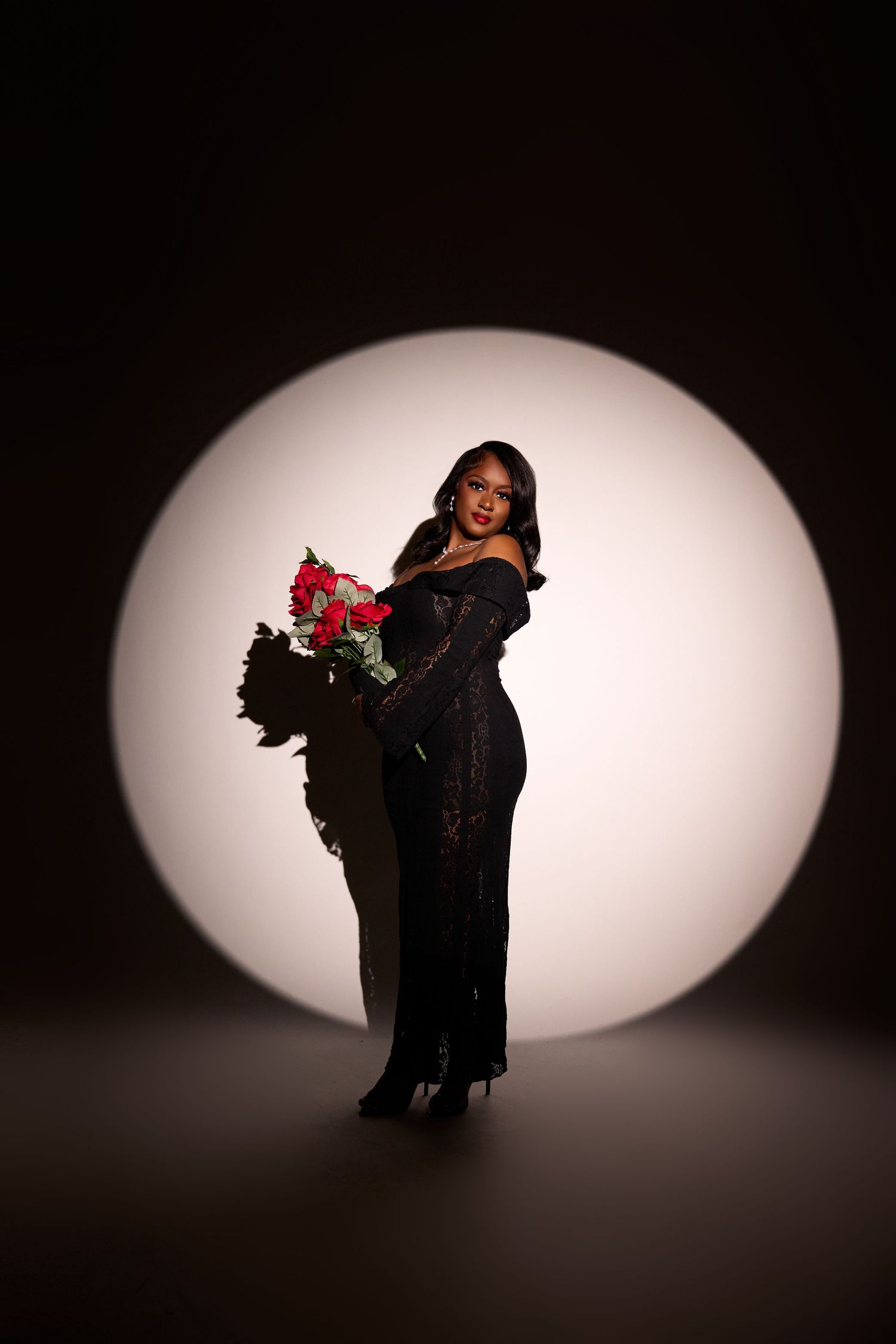 Artistic silhouette photos with dramatic oval lighting and red flower accent.