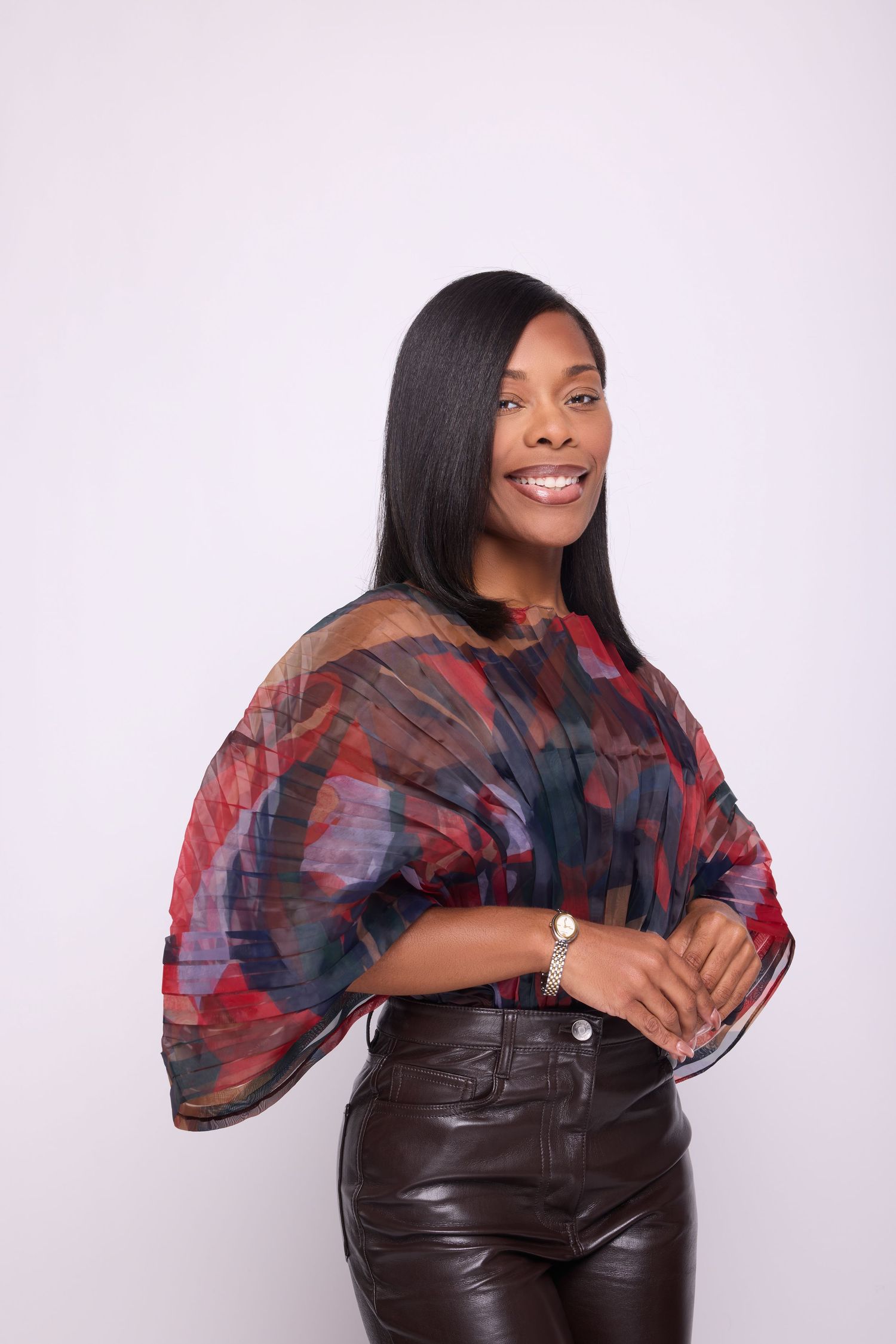 Studio fashion shots featuring flowing red and blue patterned top with leather pants.