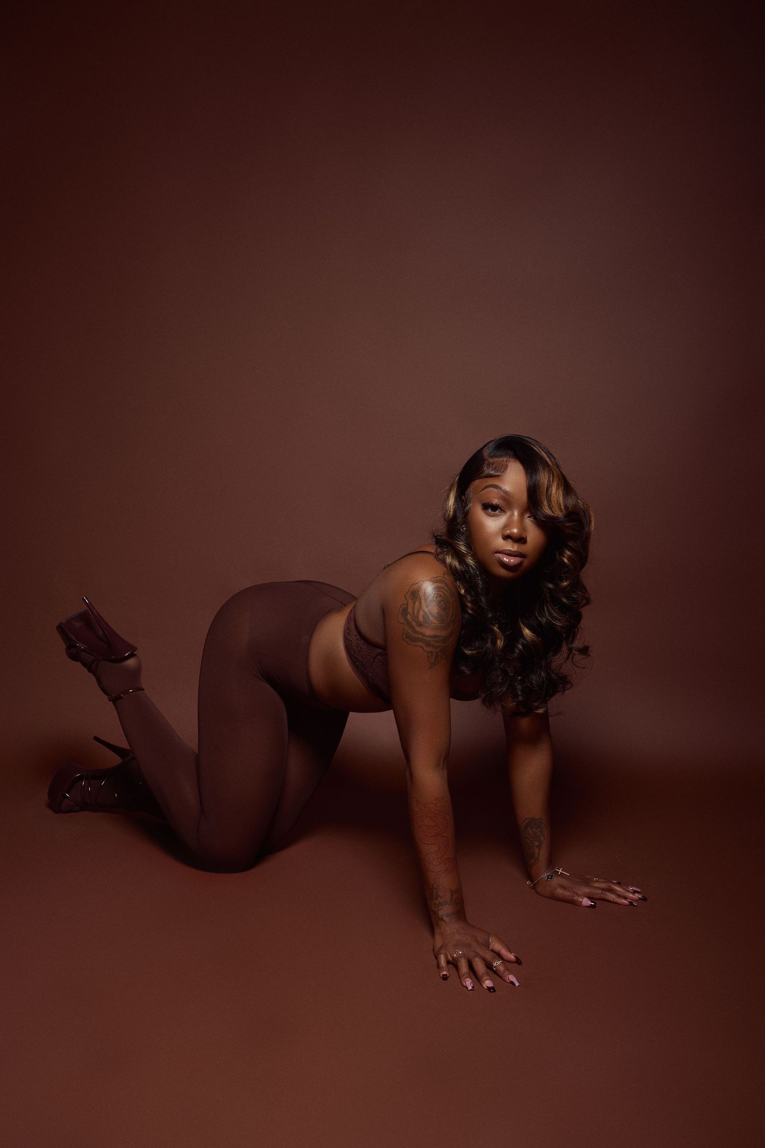 Artistic nude photography series against brown backdrop with dramatic poses.