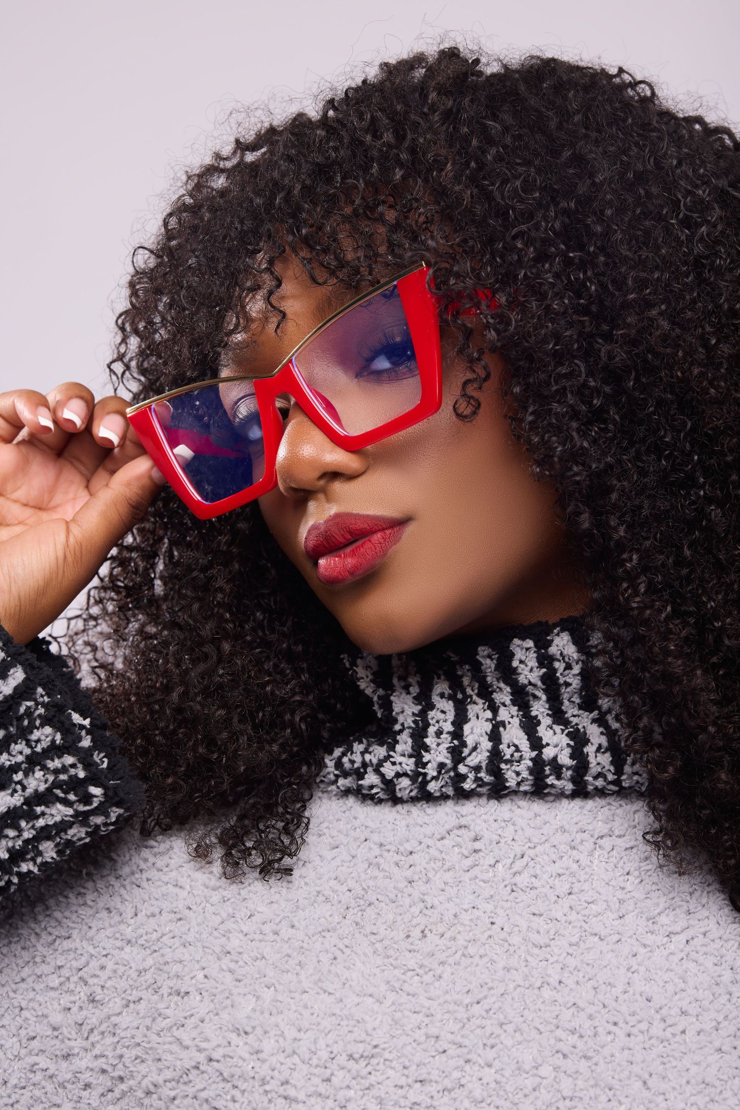 Stylish red sunglasses and curly hair featured in artistic beauty shots.