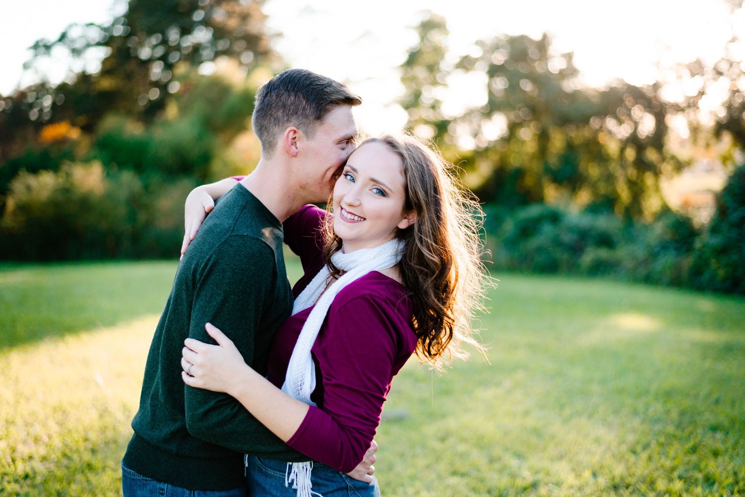 Sweet romantic moment captured between couple outdoors during golden hour.