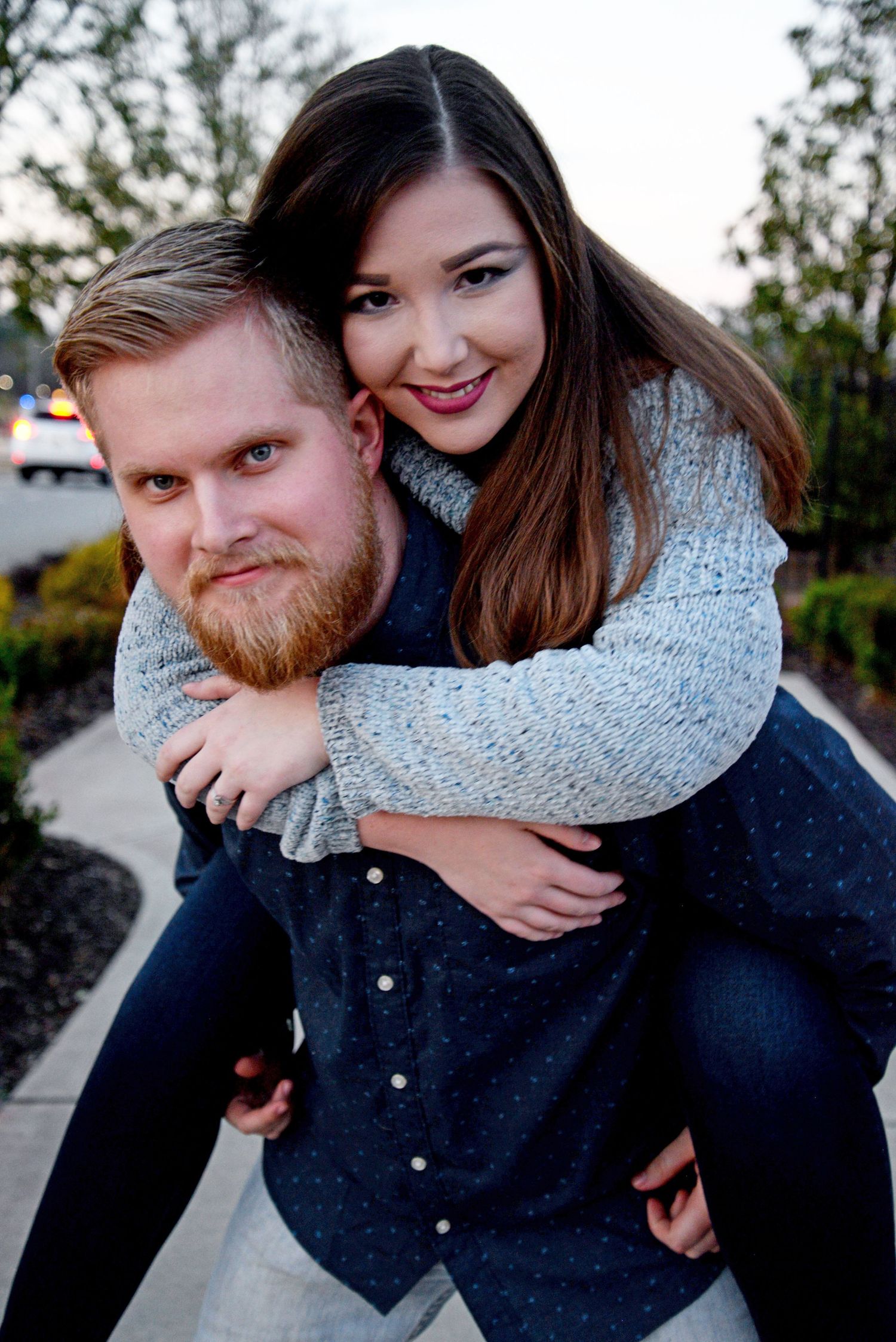 Happy couple sharing a playful piggyback moment outdoors.