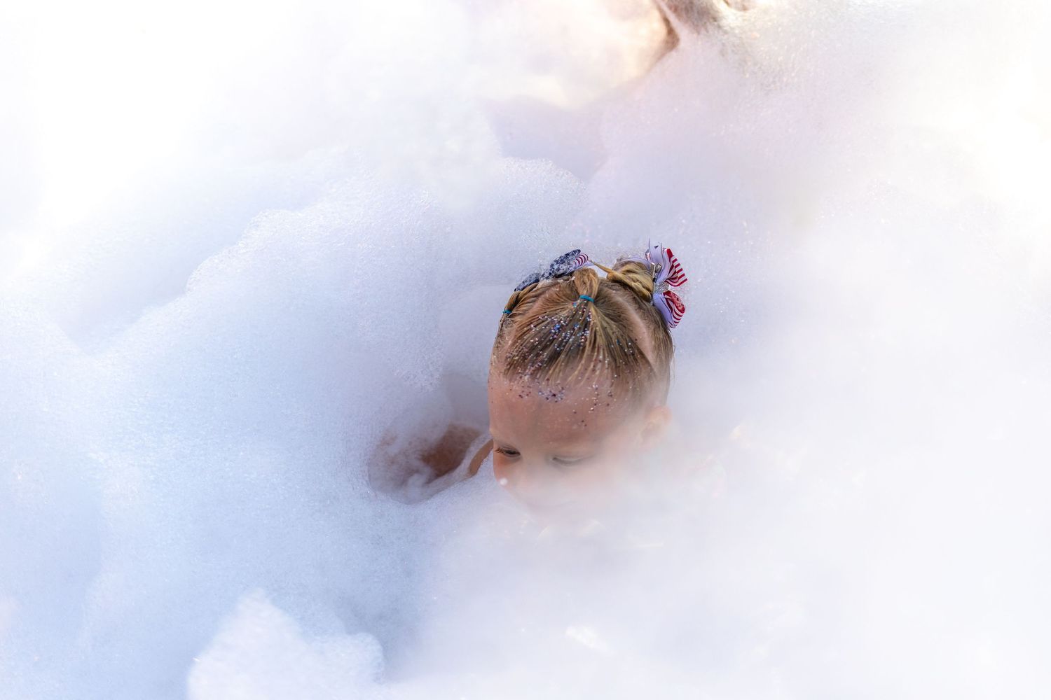 Smoke effects creating dramatic atmosphere at an outdoor car show.