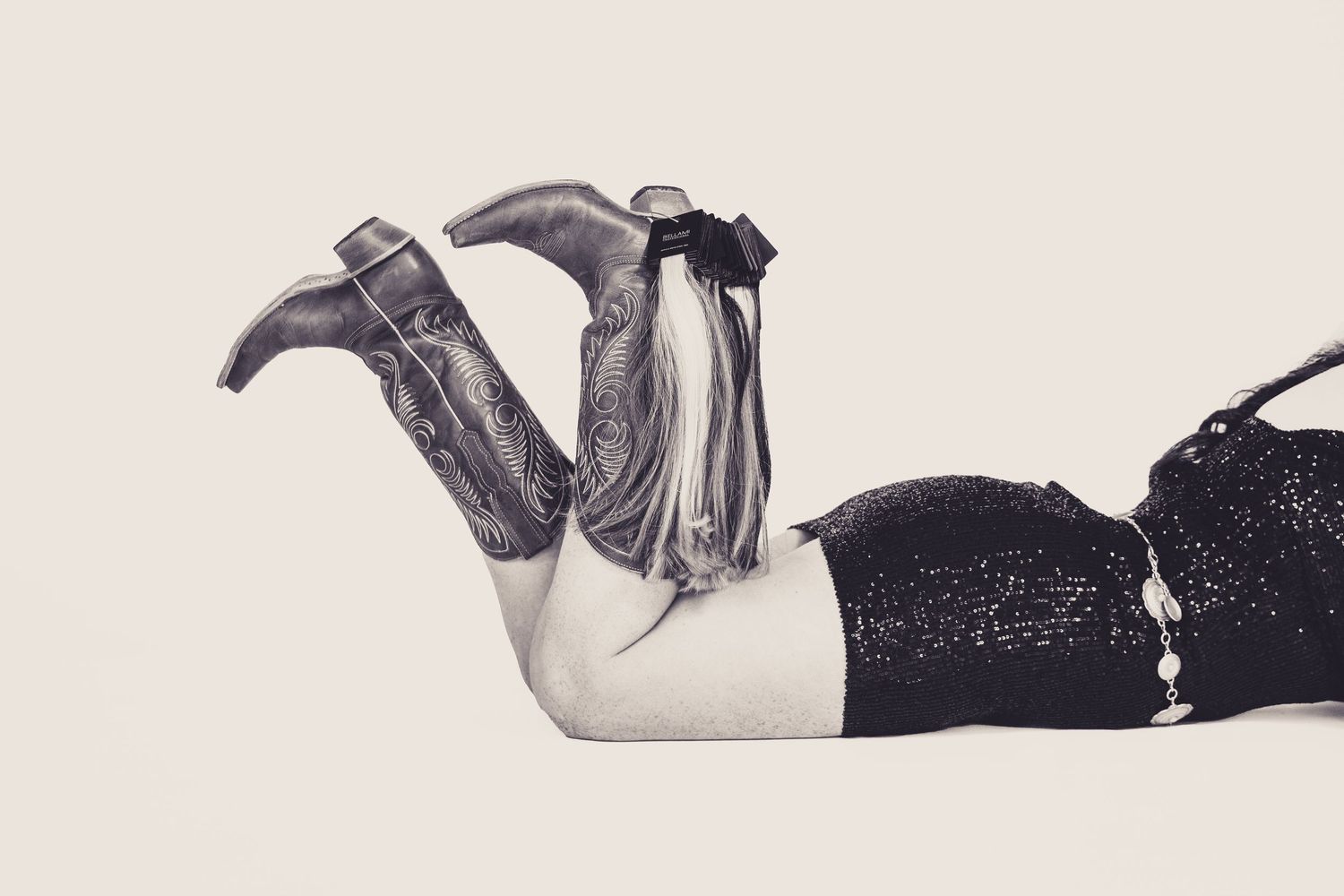 A black and white photo collage showing close-up details of a person lying down in various artistic poses.