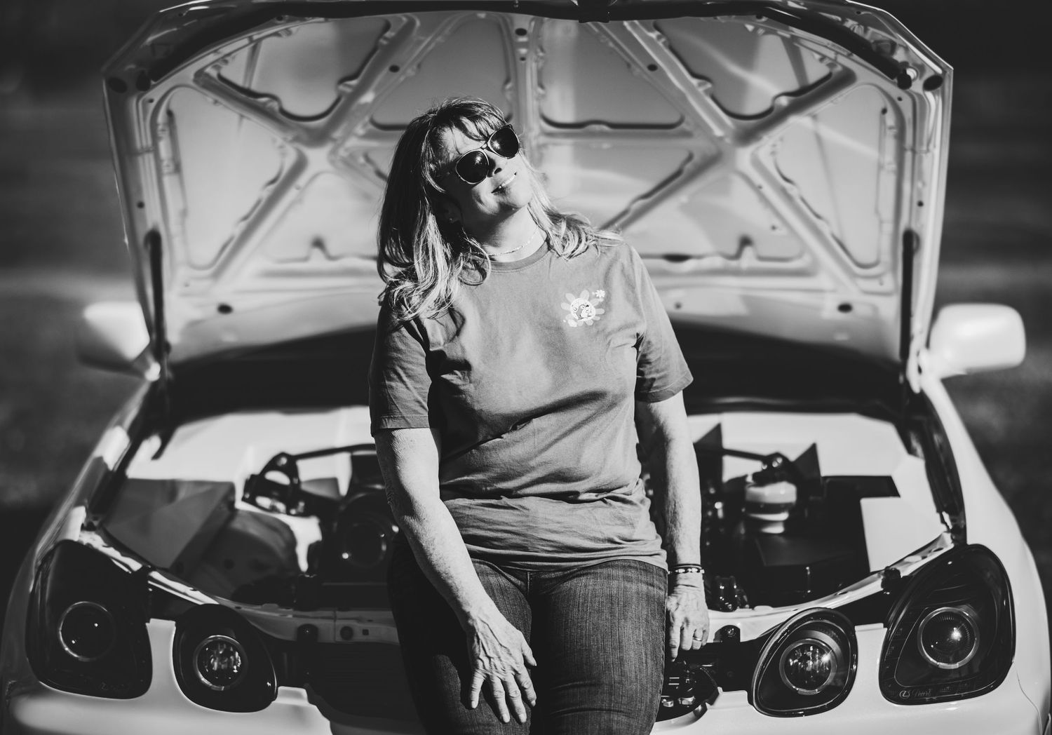Black and white photo sequence showing someone getting into a car and adjusting the rearview mirror.