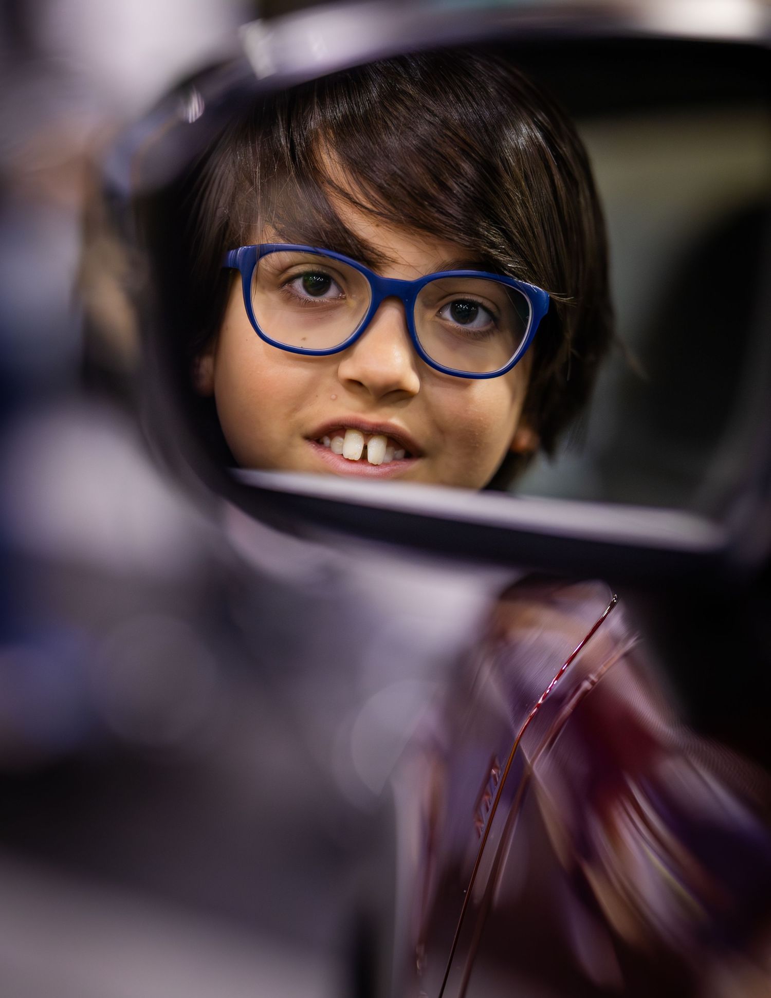Close-up view through a car window with reflections and interior details.