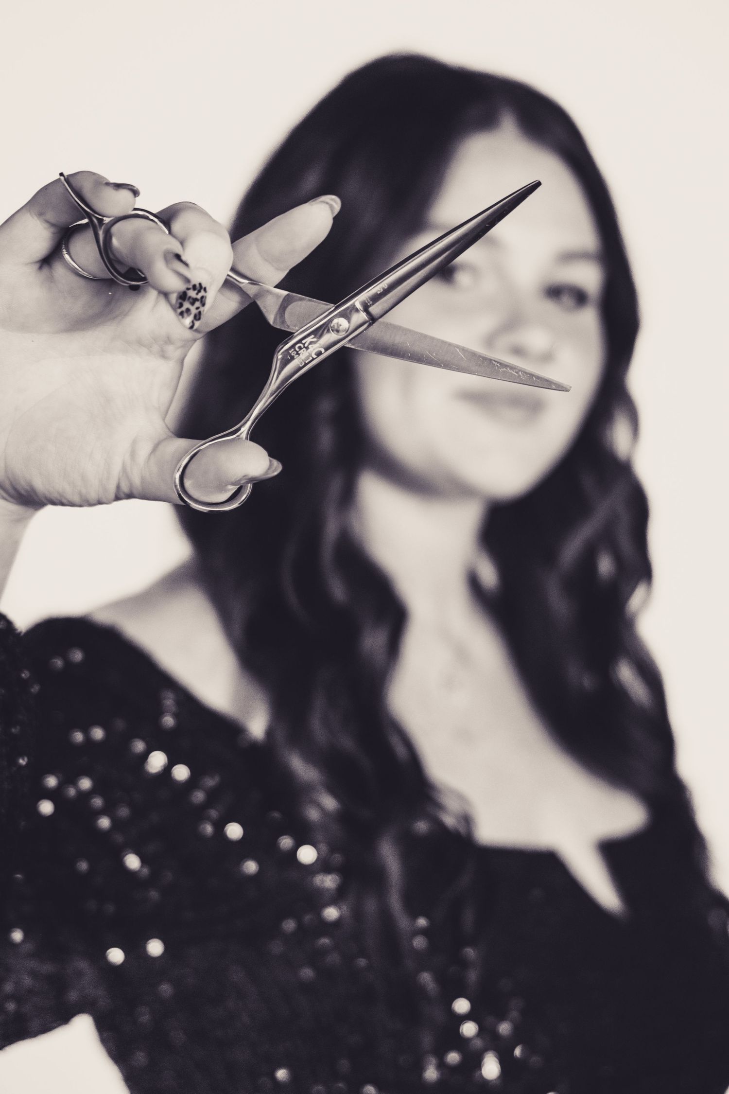 Black and white studio photo featuring professional hairstyling scissors.