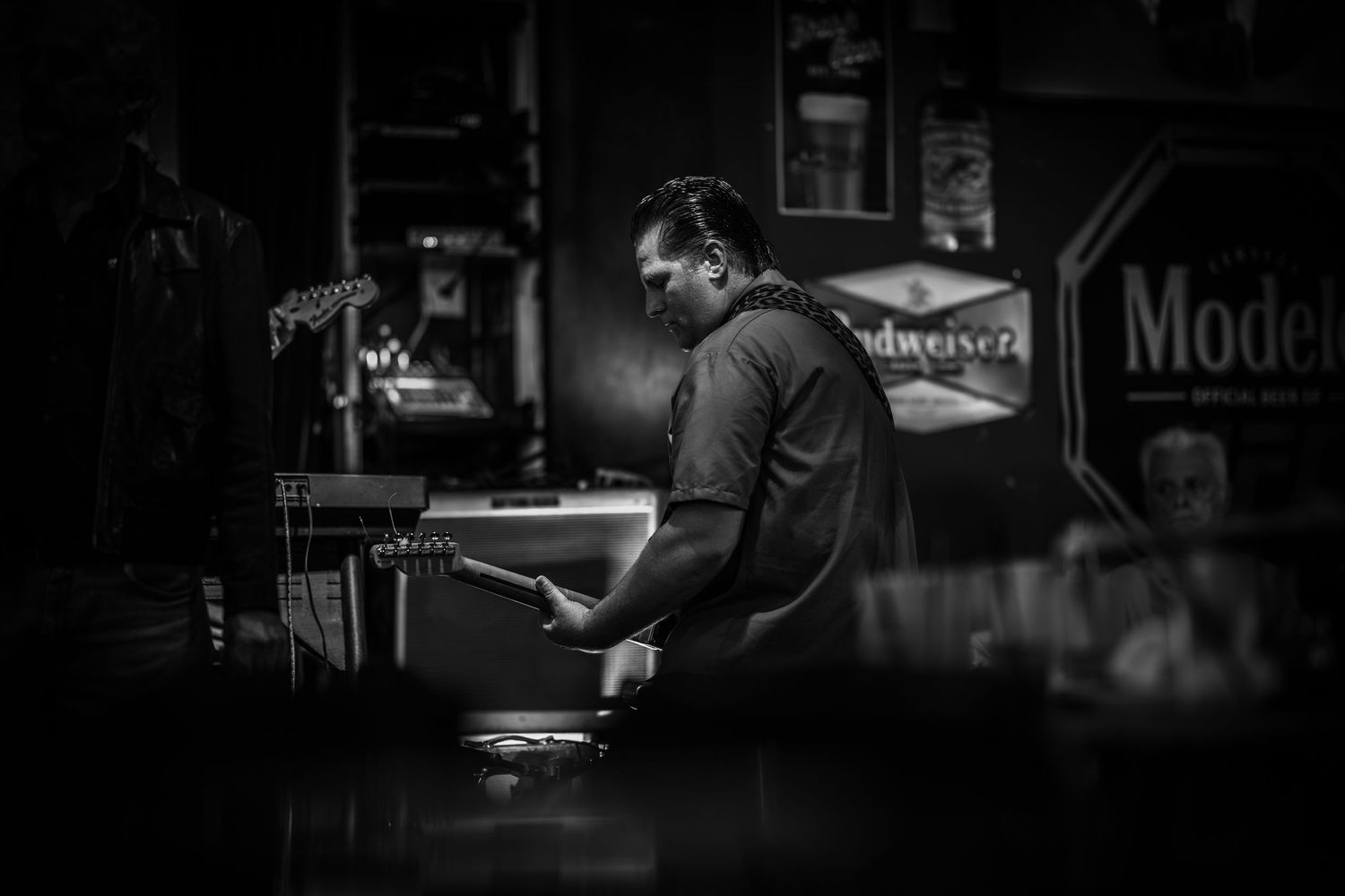 Atmospheric black and white photo of musicians performing in low light.