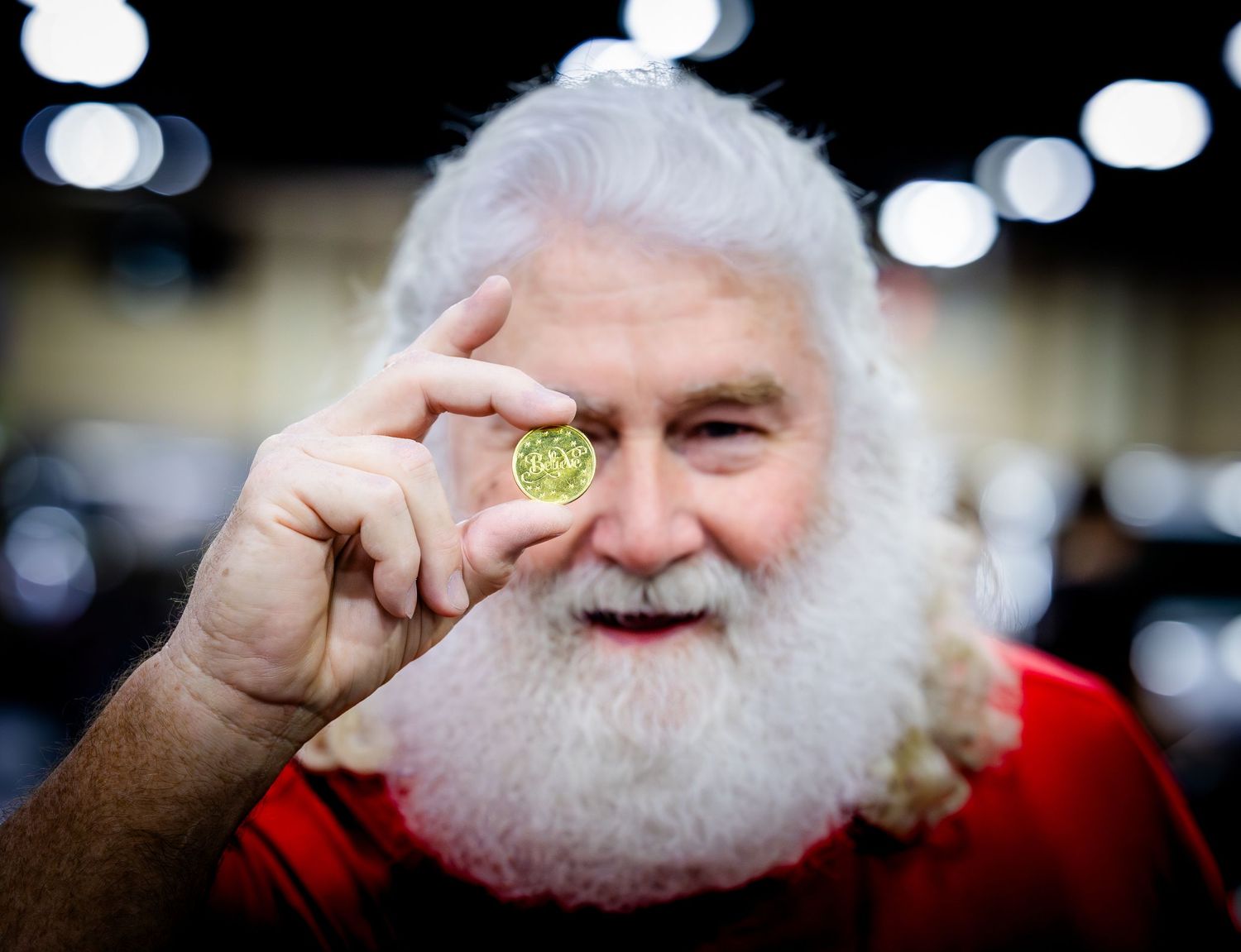 Close-up sequence of someone in red adjusting their white beard.